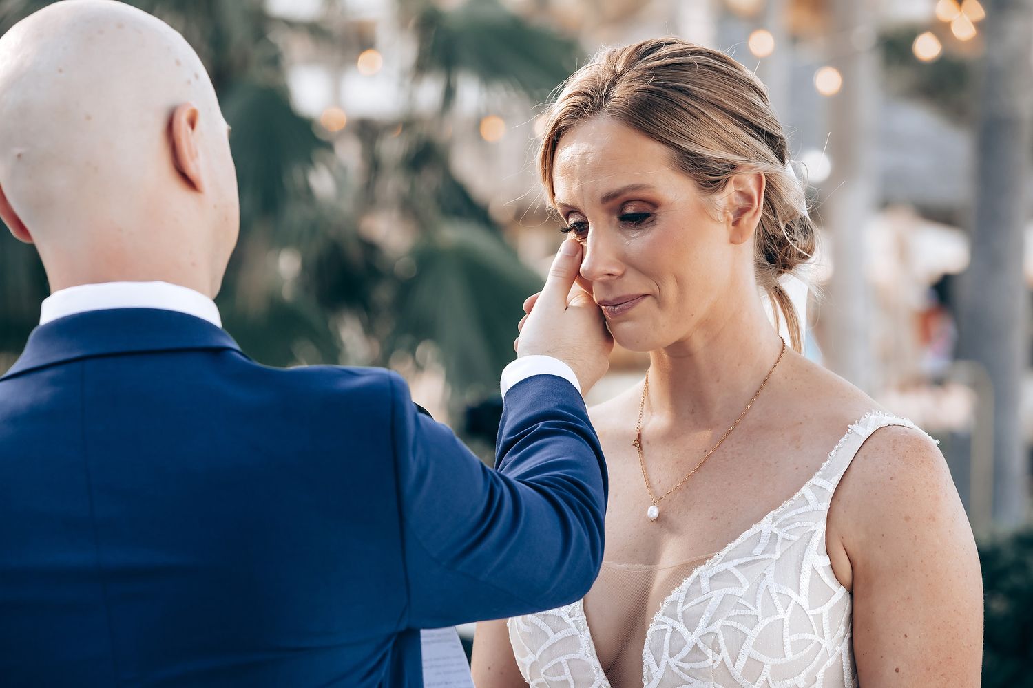 A bride and groom sharing a tender moment during their wedding ceremony.