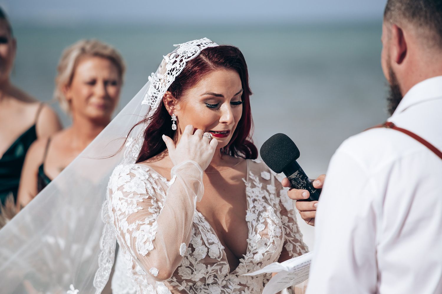 Couple shares intimate moments during their beach wedding ceremony.