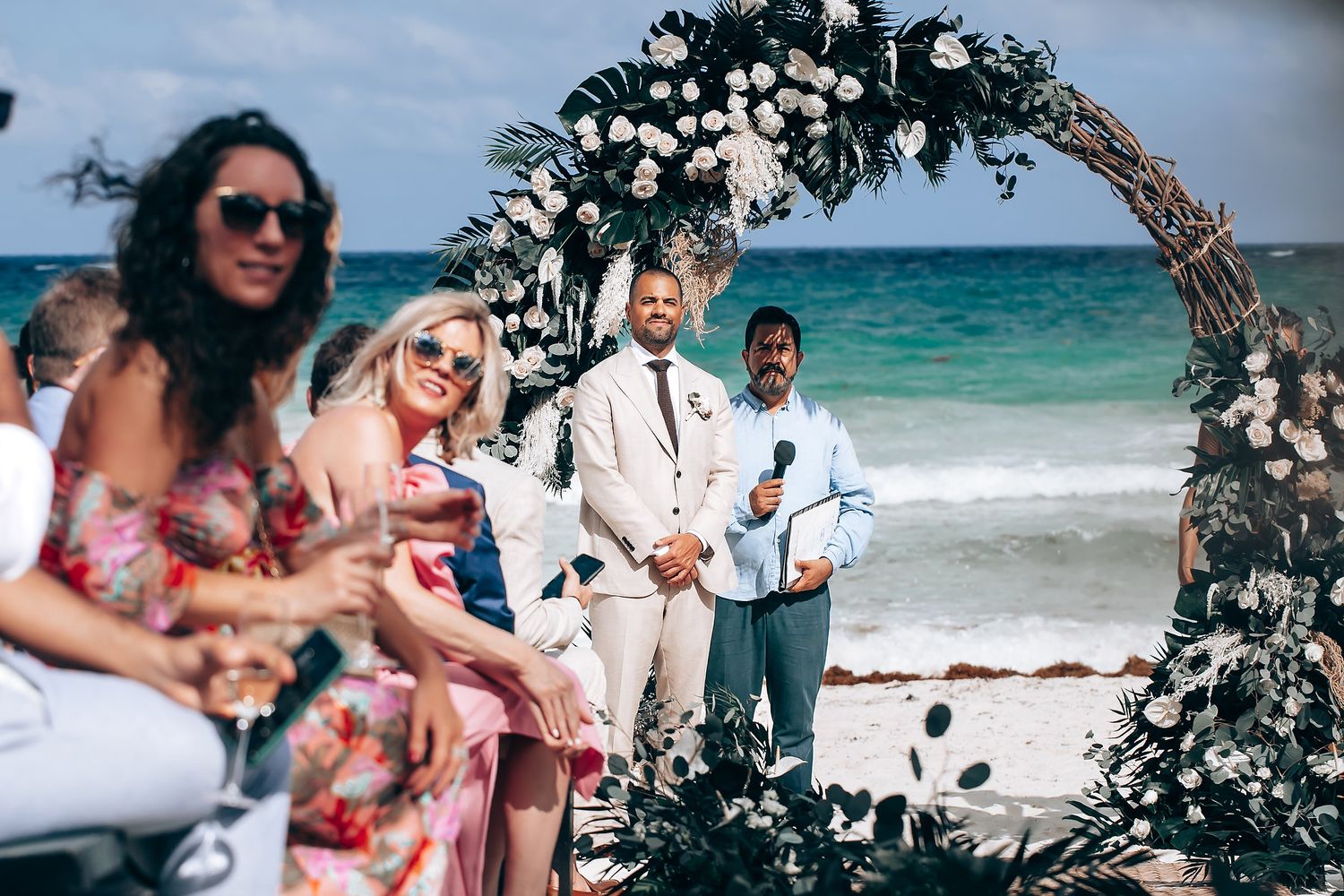 A collection of beach wedding moments showing floral arches, turquoise waters, and celebrations in a tropical paradise.