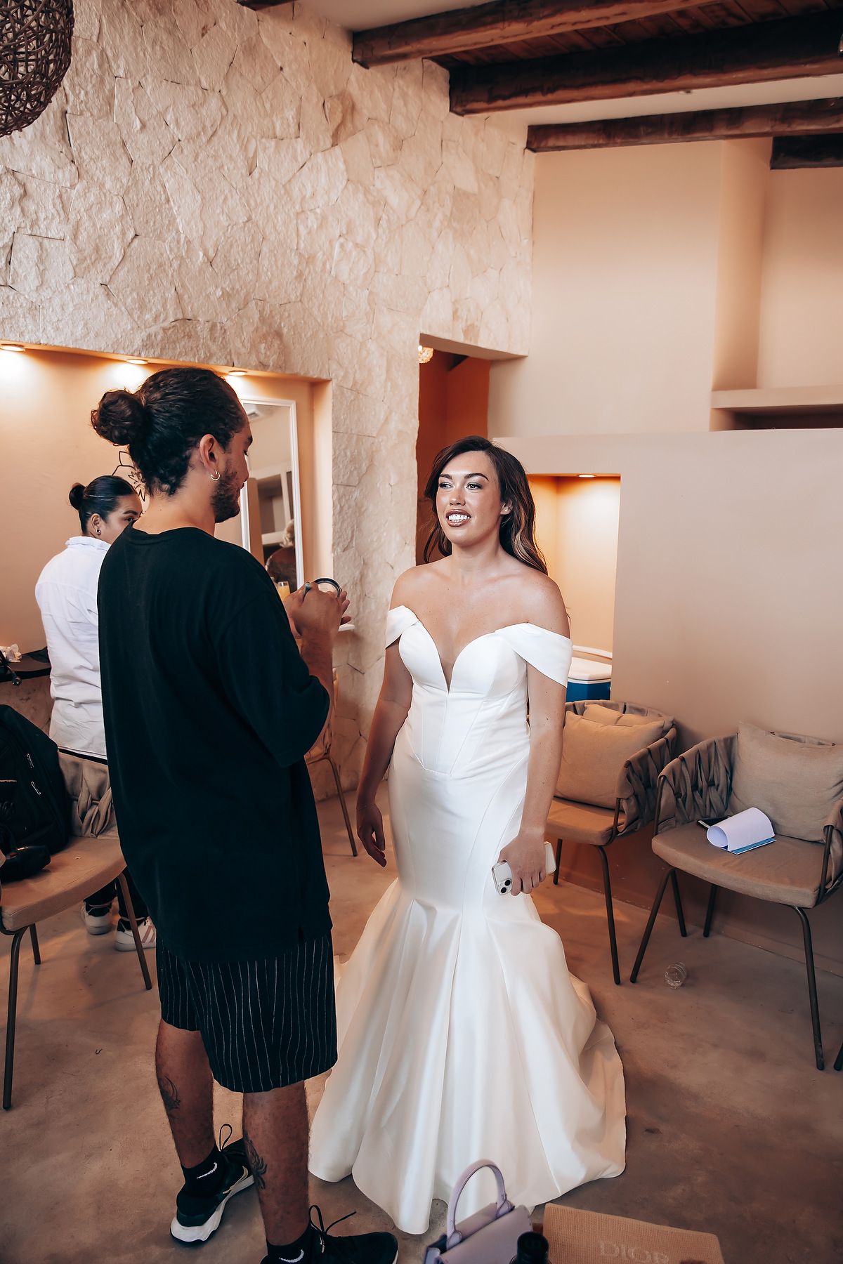 A sequence of photos showing a bride getting ready in a white wedding dress in a rustic room with exposed beams.