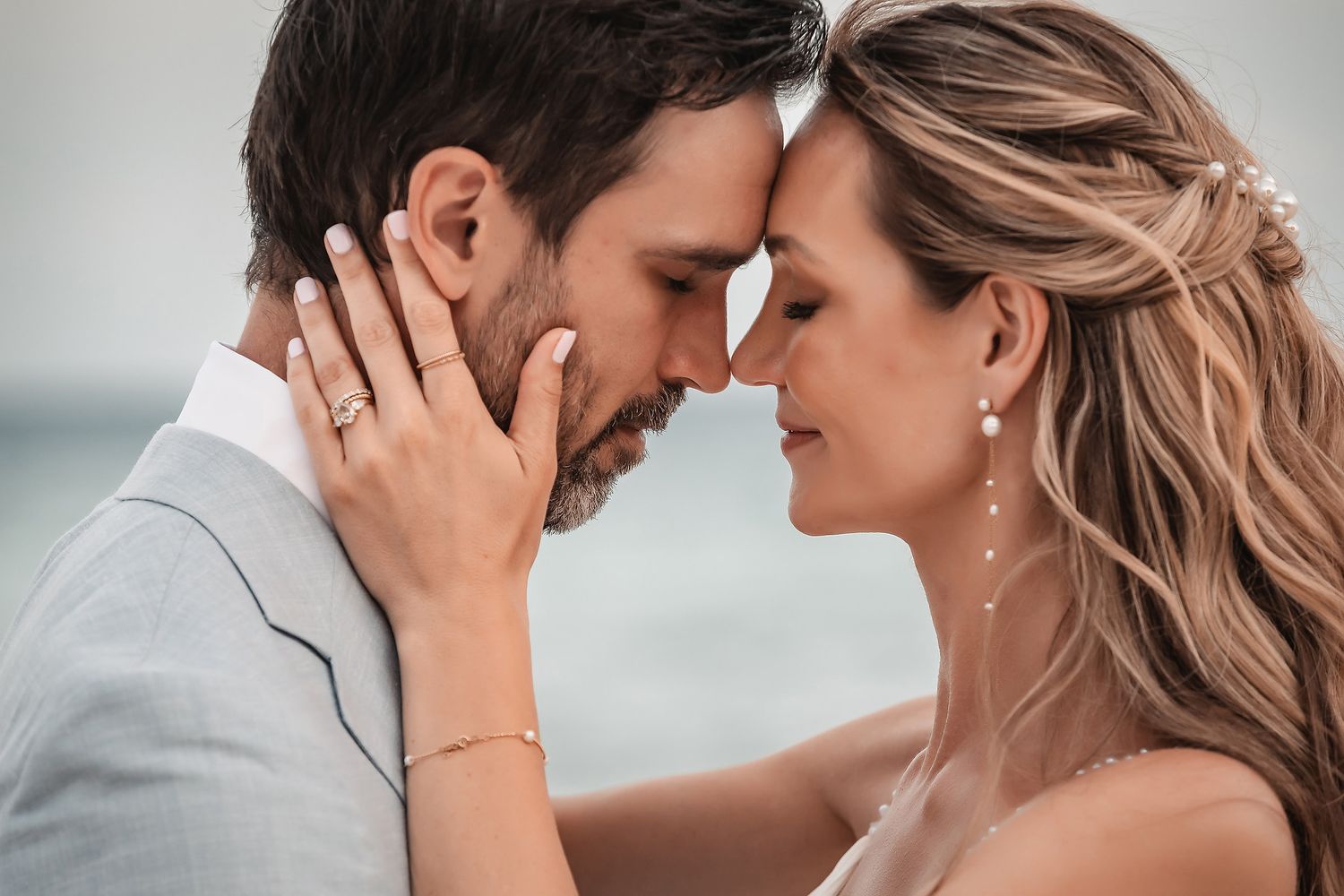 Loving couple shares an intimate moment during their beachside wedding photoshoot.