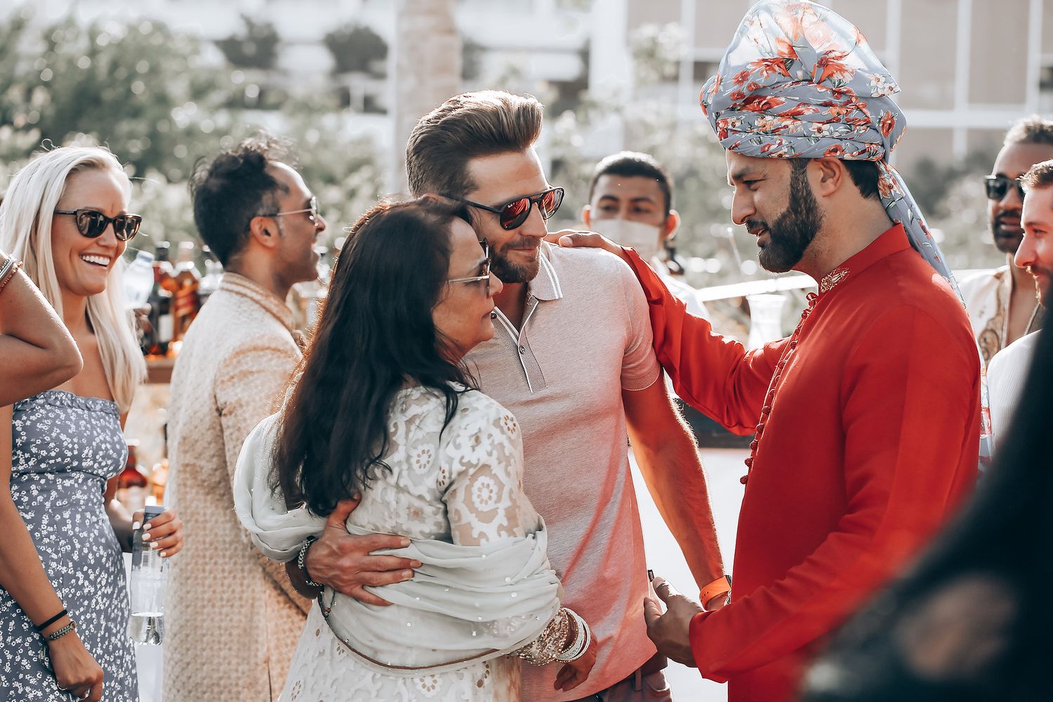 People gathered at an outdoor event wearing red and white outfits while socializing and mingling together.