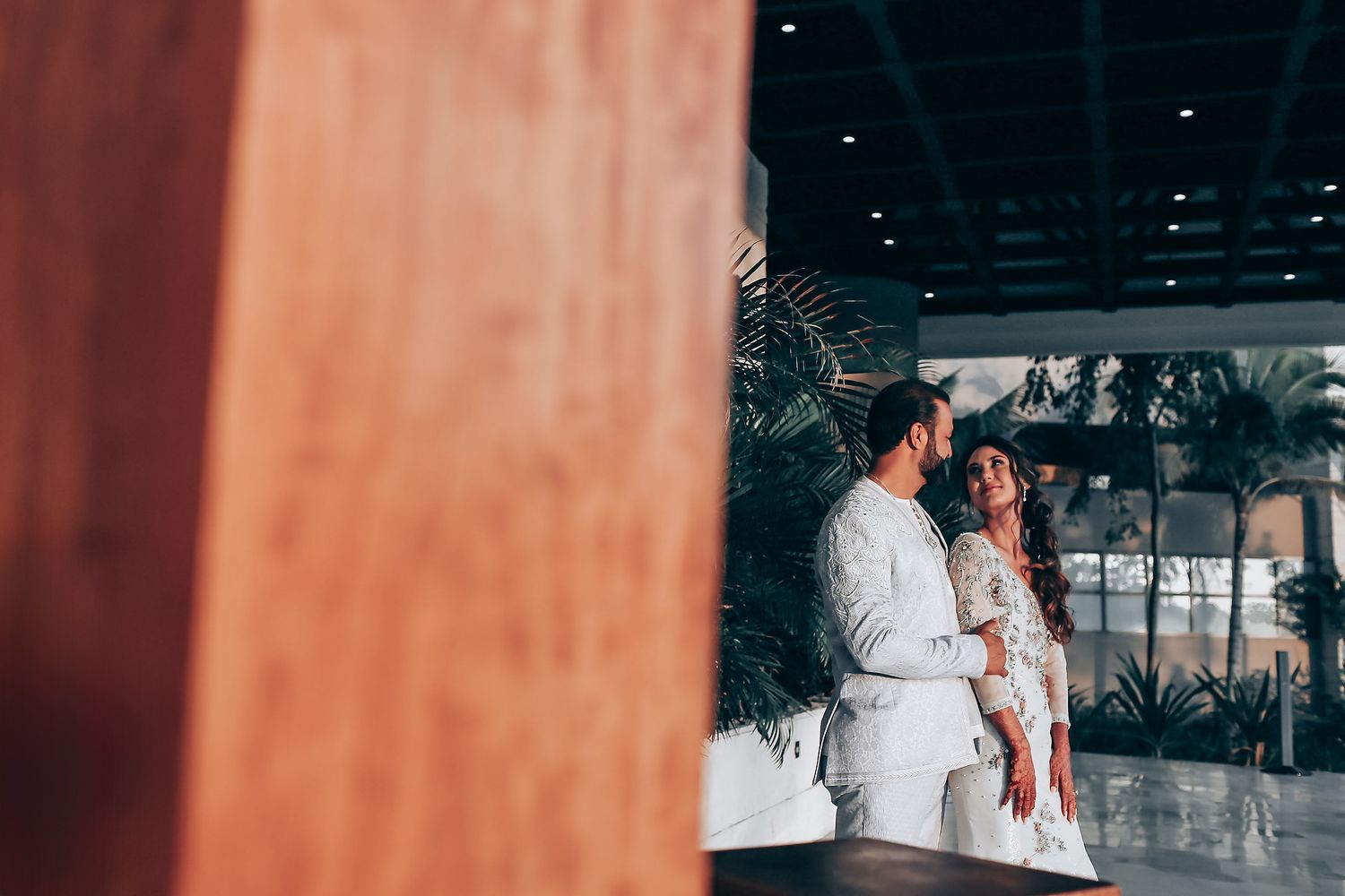 Wedding guests enjoy dancing and celebrating at an elegant indoor reception venue.