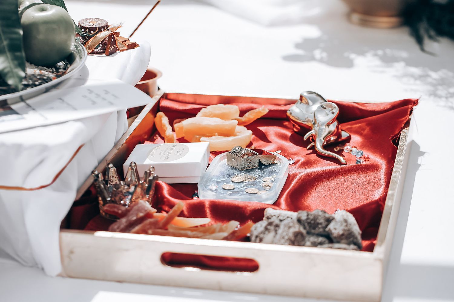 A white wooden tray filled with assorted seafood including fresh carrots and various items on ice.