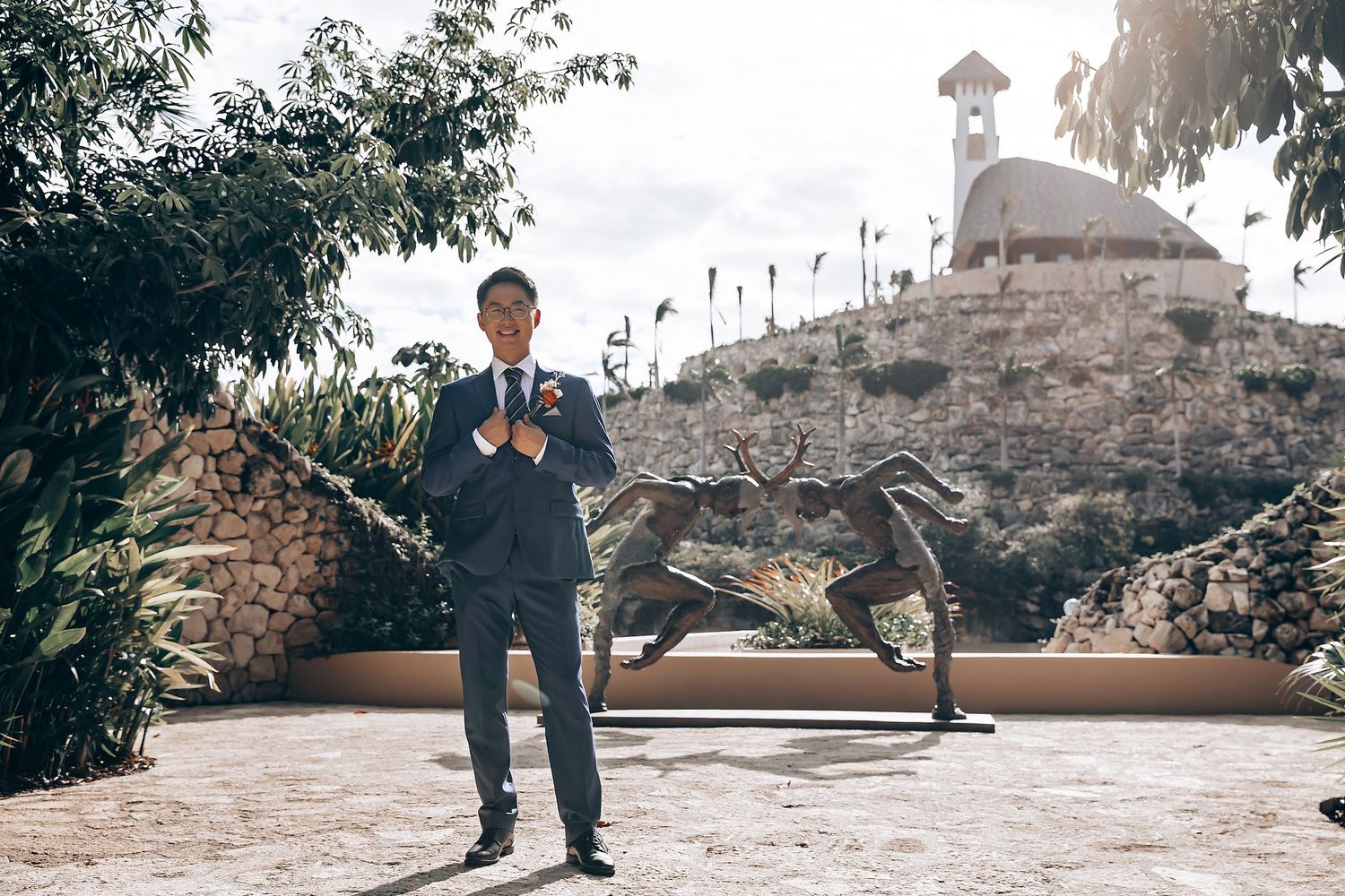 Scenic outdoor wedding venue with stone walls and natural landscaping.
