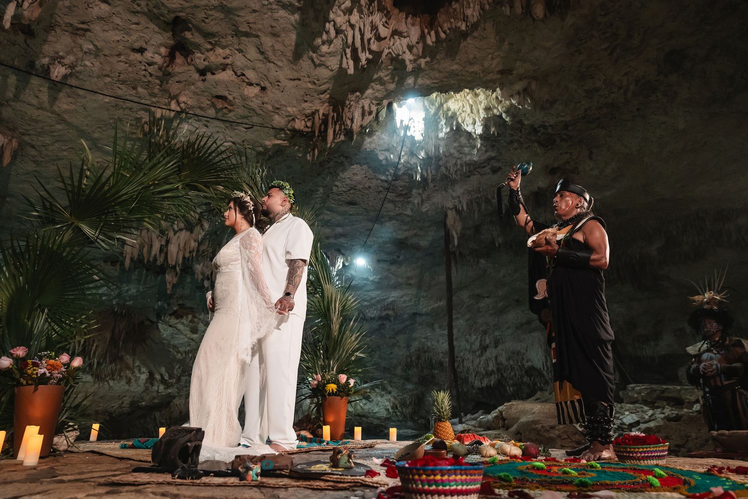 Atmospheric cave wedding ceremony with natural rock formations and mood lighting.