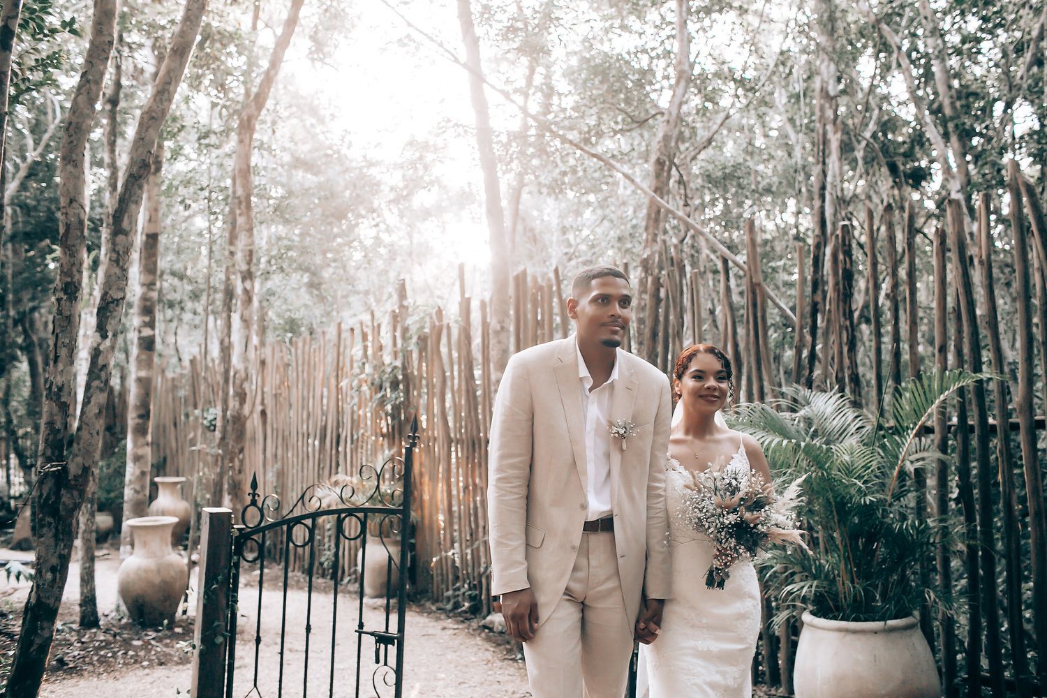 An elegant outdoor wedding ceremony setup with rows of chairs along a wooded path.