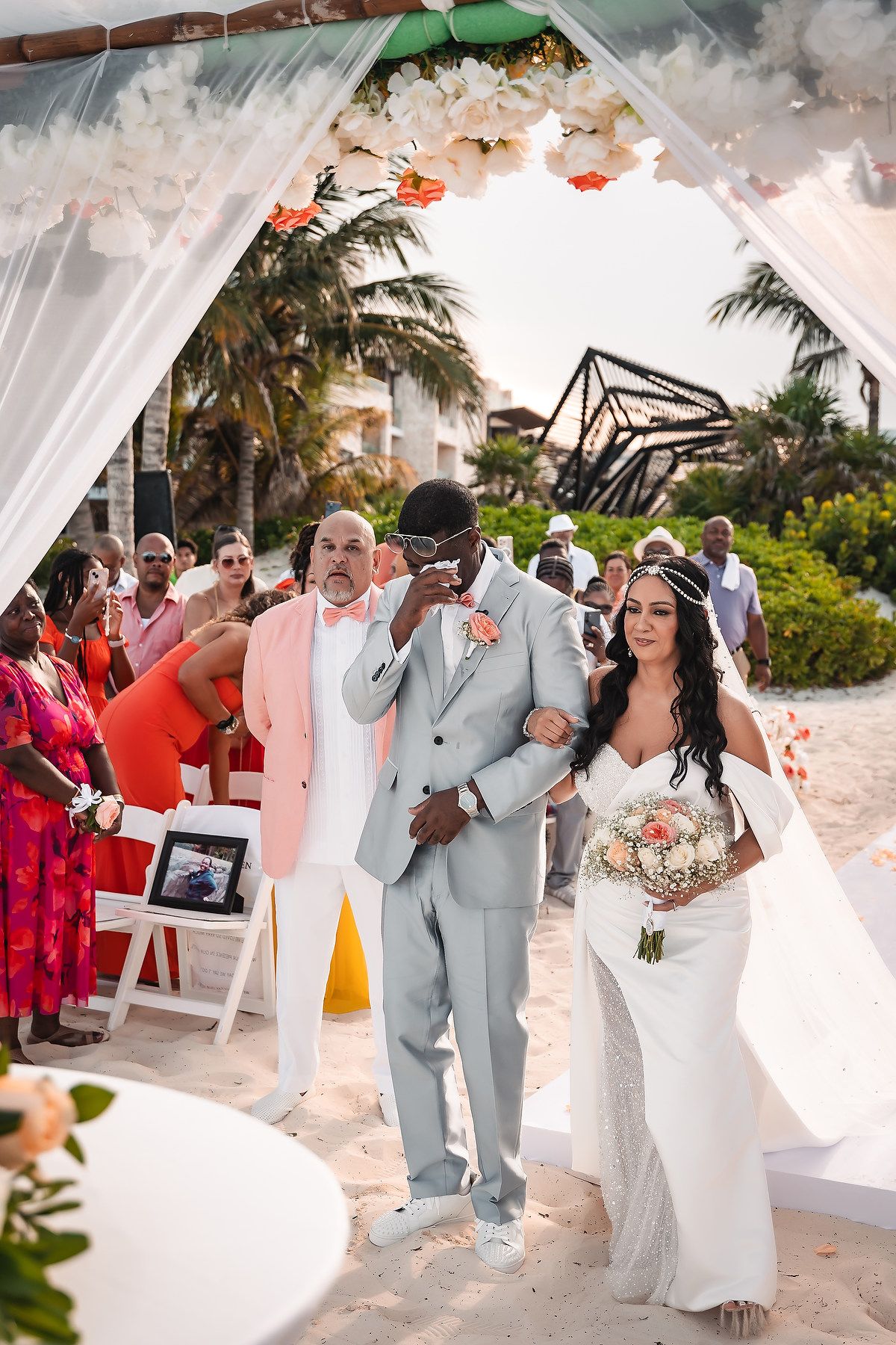 Beachside wedding ceremony procession with light blue and white color scheme.