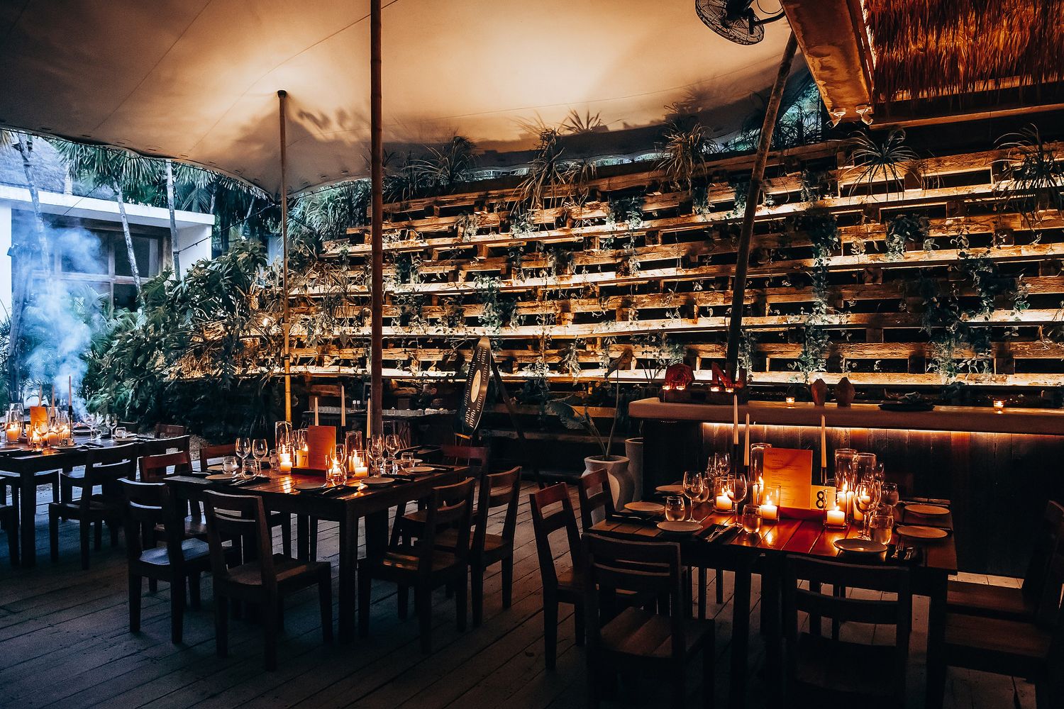 Elegant wedding reception venue with warm lighting and rustic wooden tables.