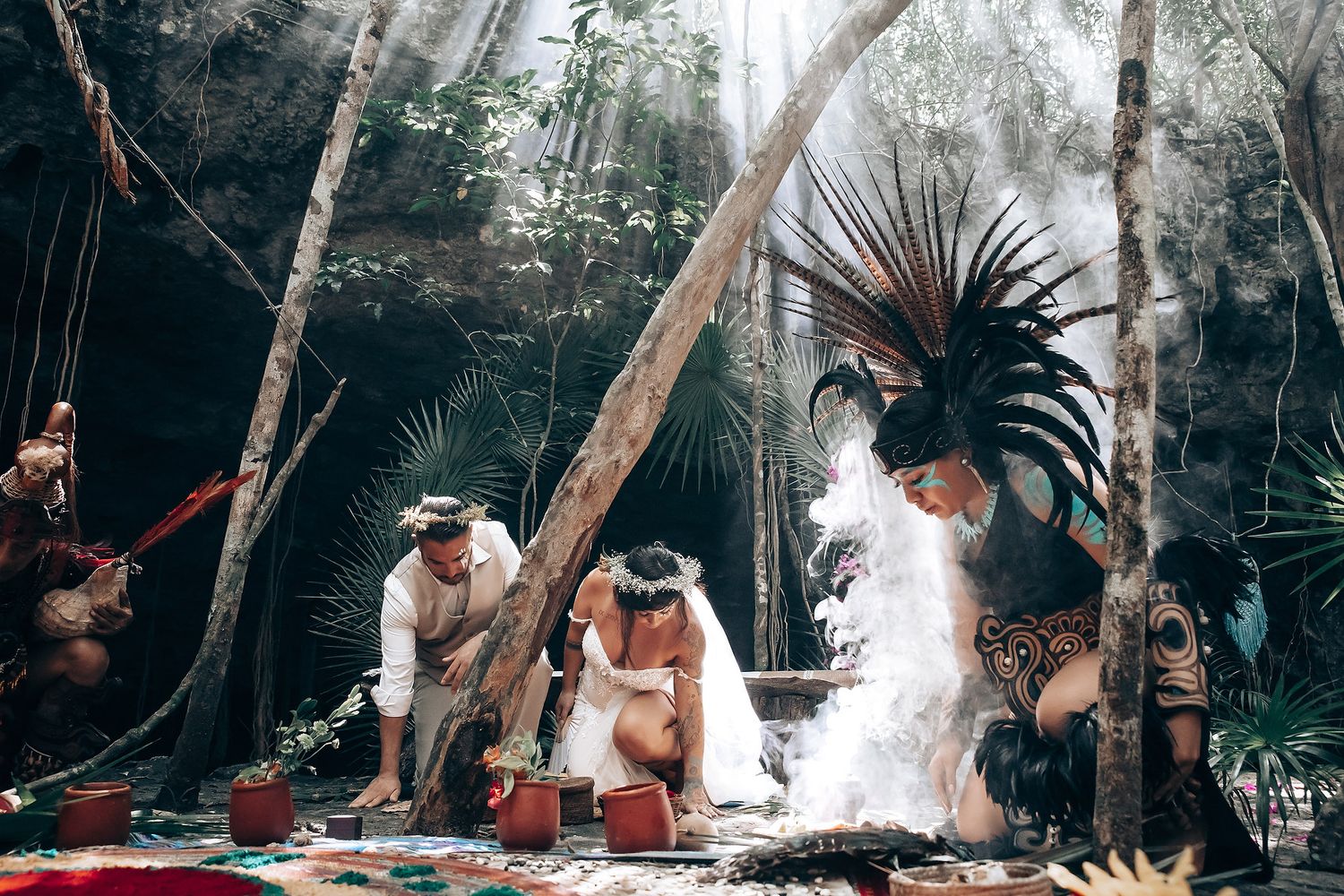 A romantic outdoor wedding ceremony takes place in a lush tropical garden setting with palm trees and natural decor.