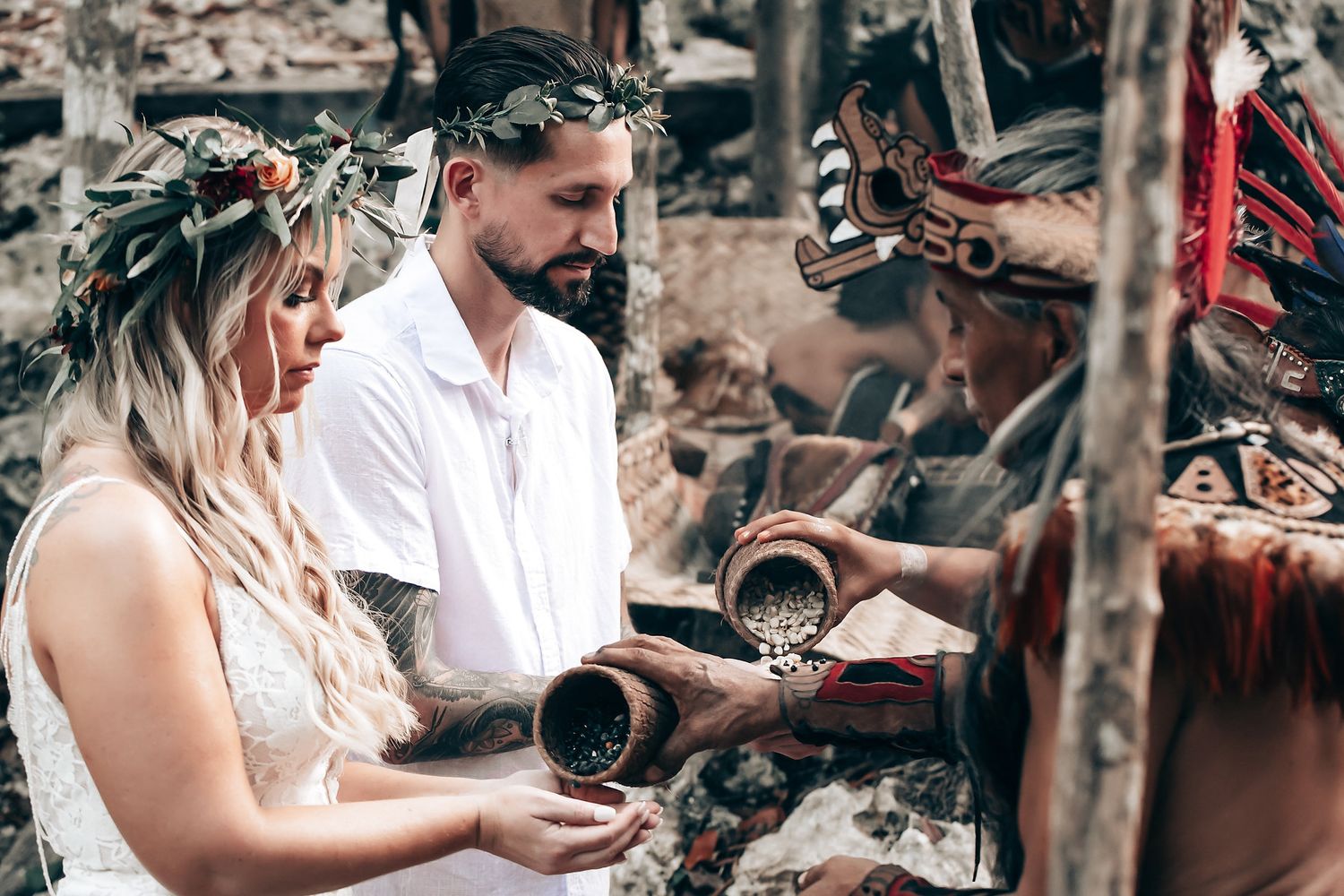 Romantic ceremony in a cave setting with traditional decorative elements and natural lighting.