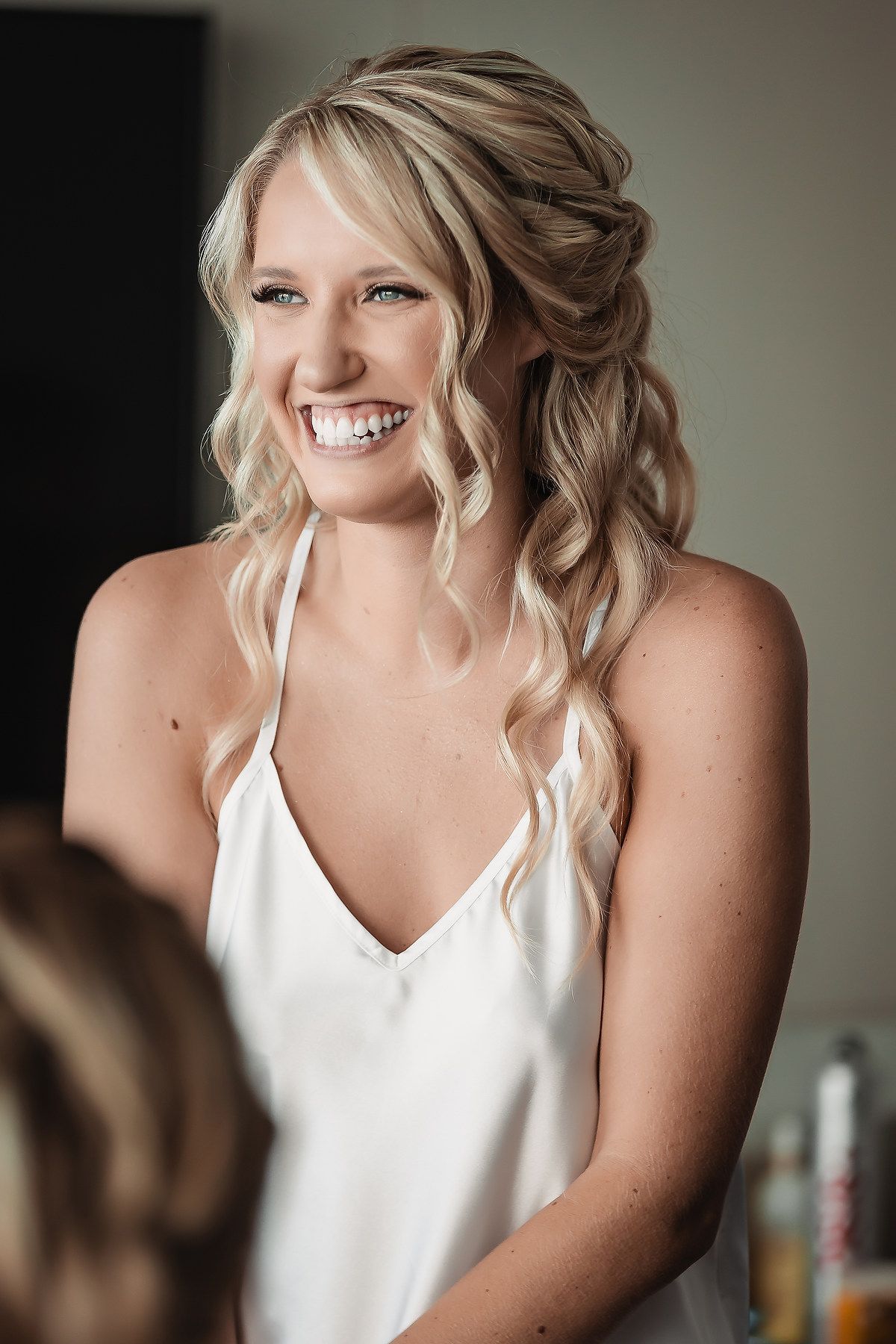 A candid series of joyful moments captured during wedding preparations in natural light.