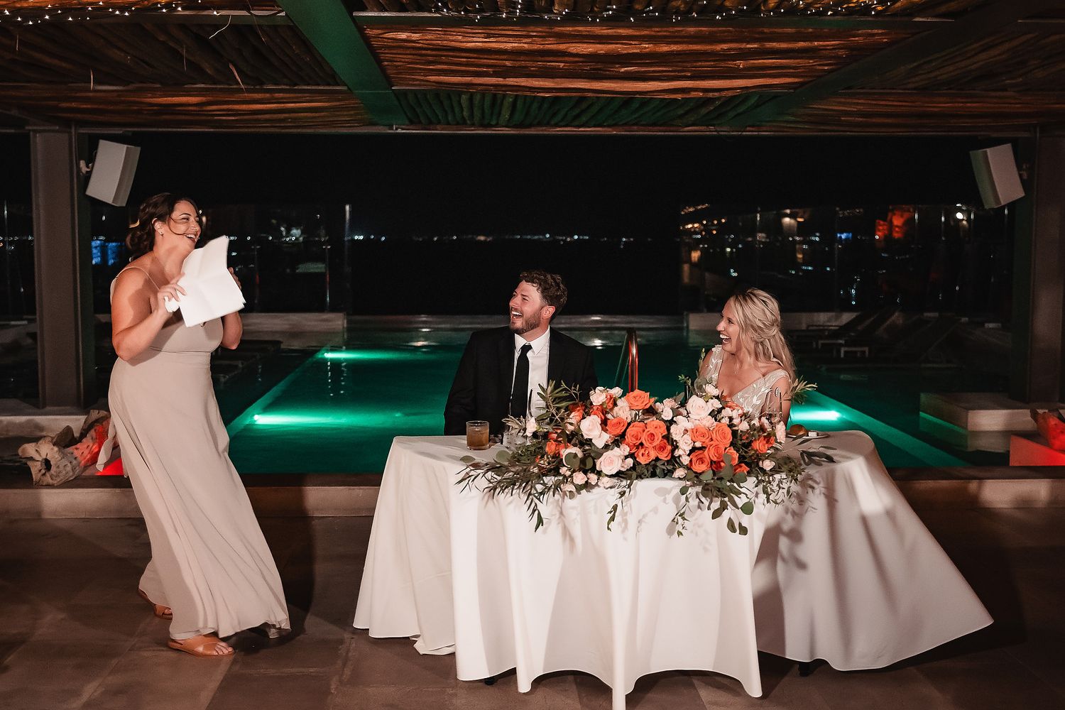 Wedding reception venue with white tablecloths and string light decor creating a romantic atmosphere.