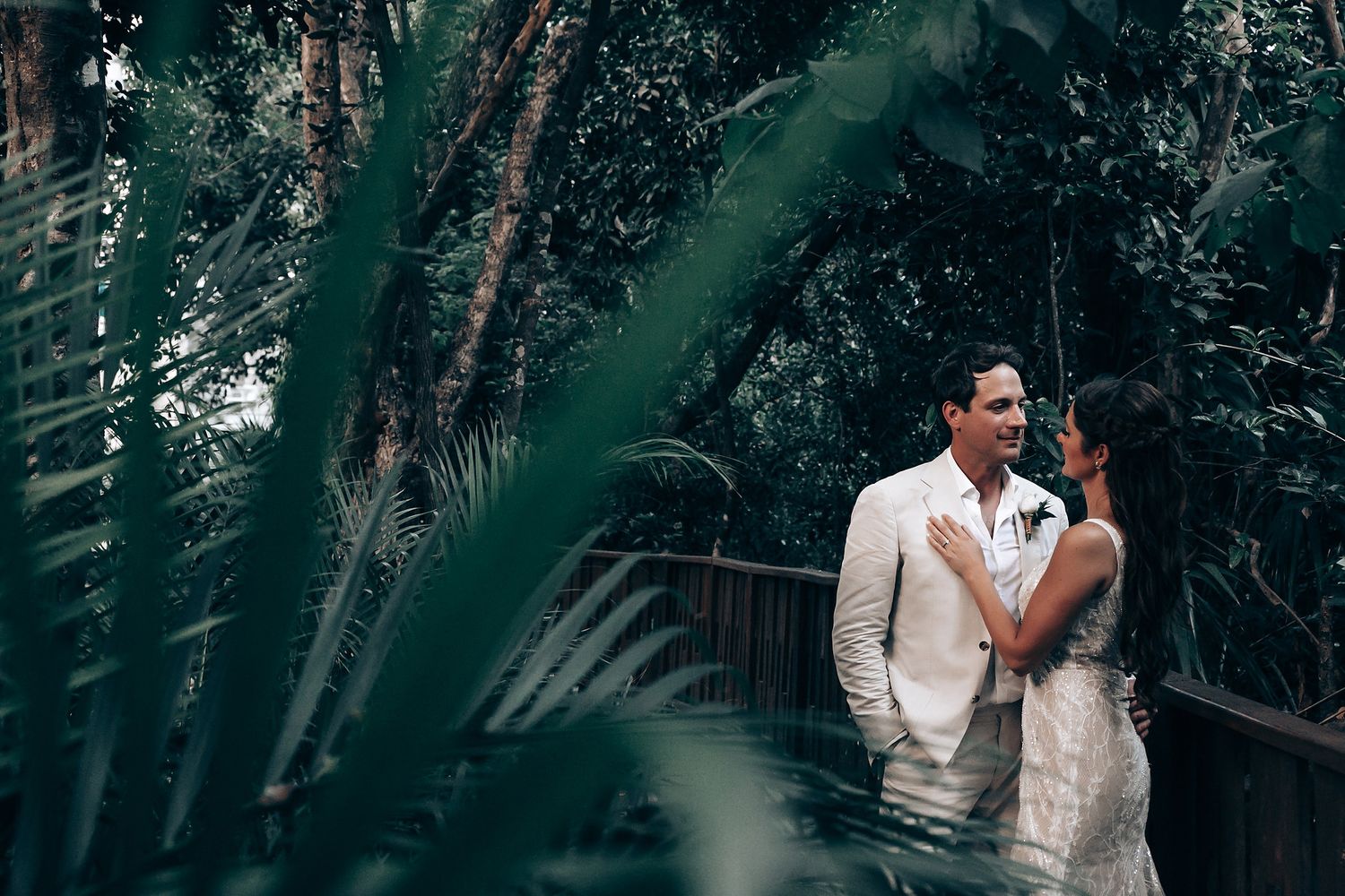 Romantic wedding couple portraits in a lush green garden setting.