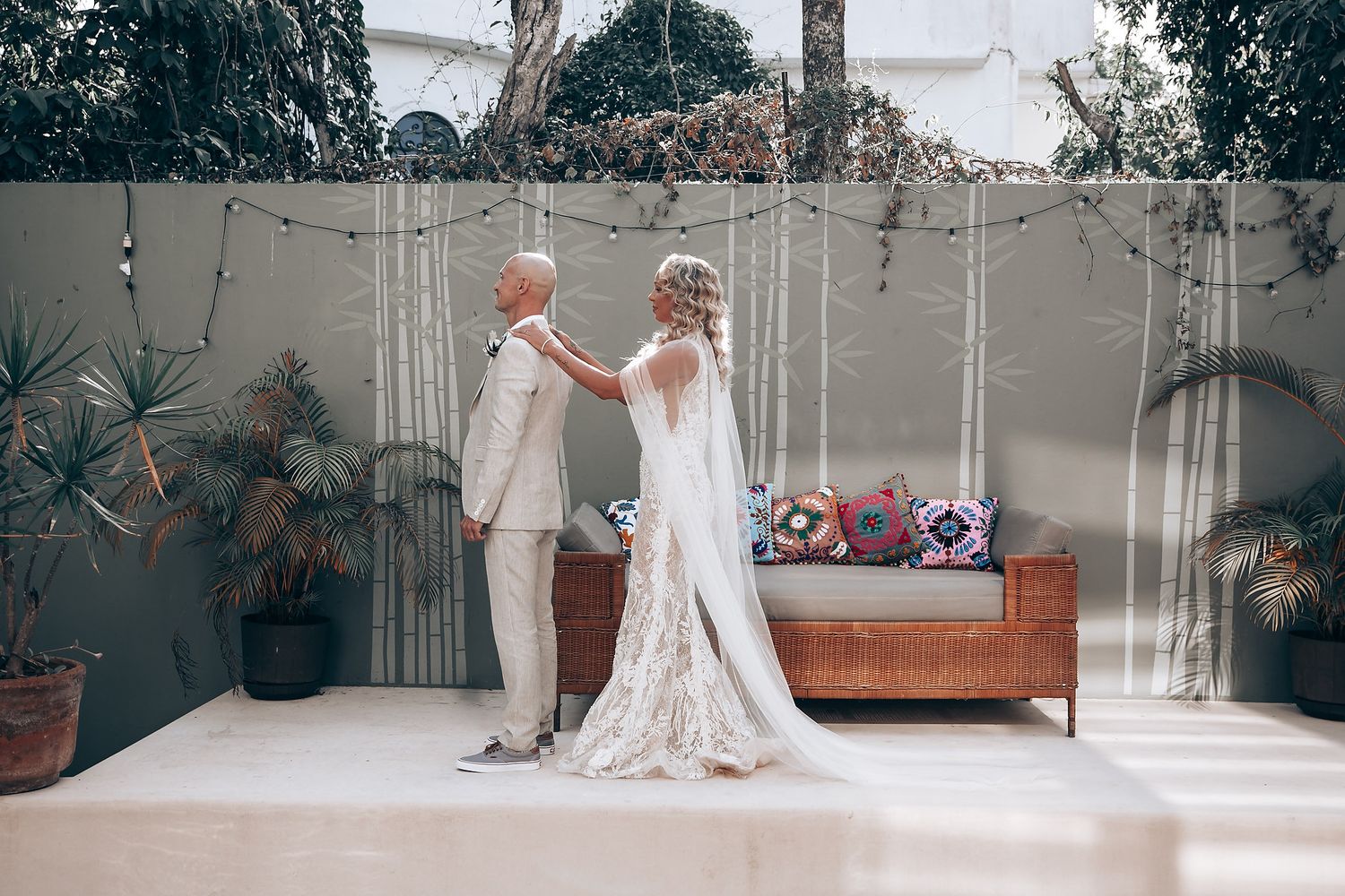 A series of indoor wedding preparation photos showing white decor and floral arrangements.