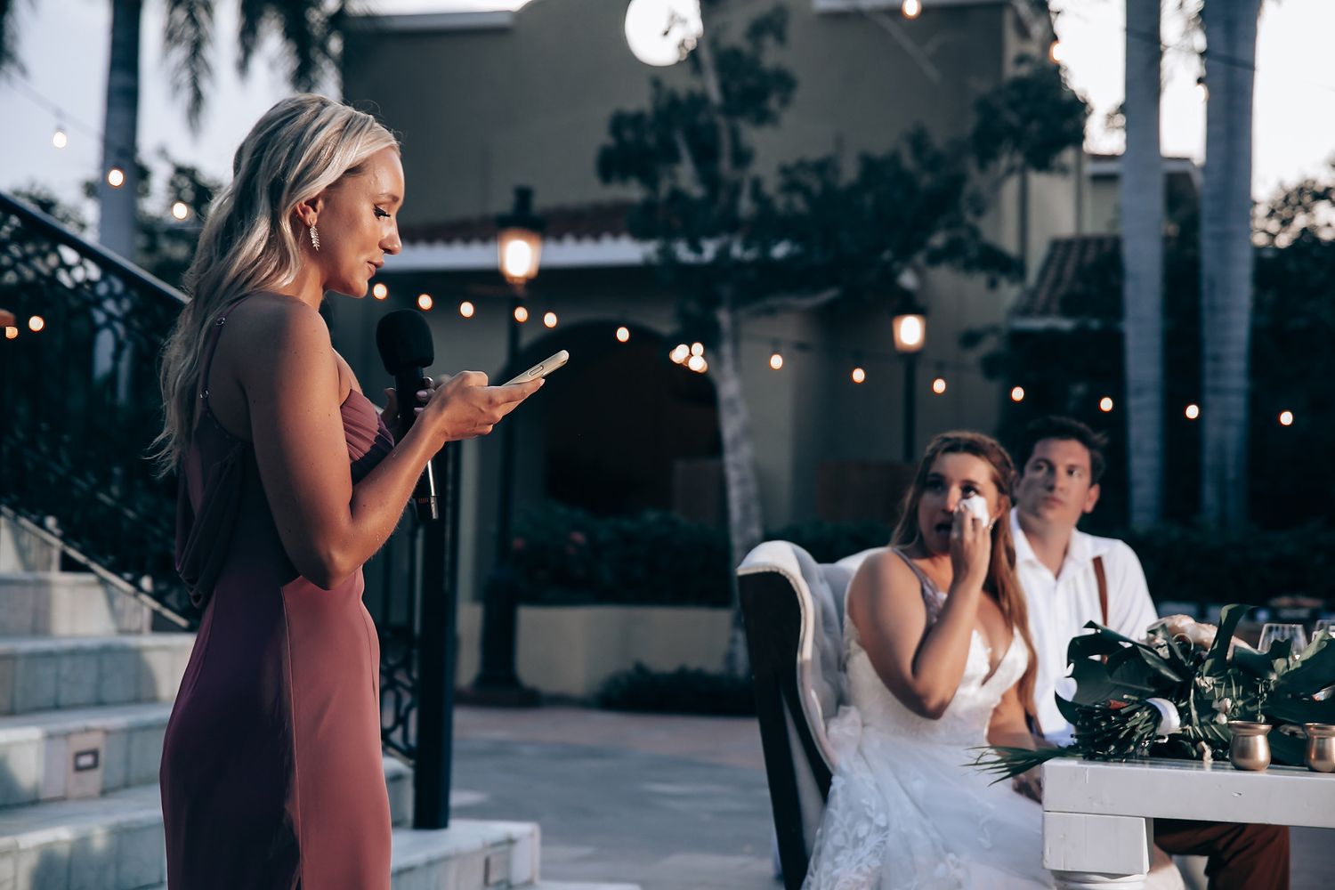 Evening wedding reception with string lights creating a romantic atmosphere.
