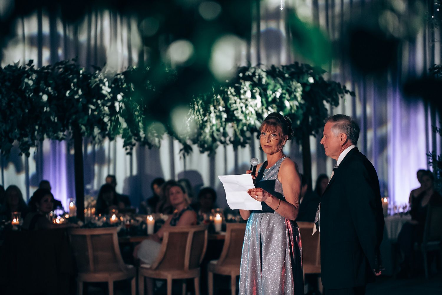 Dimly lit wedding reception venue with atmospheric lighting and decorations.