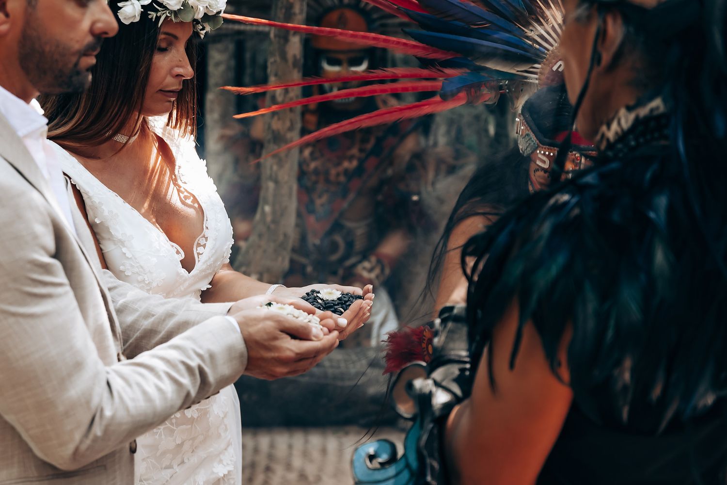 Intimate wedding ceremony with smoke elements and traditional decor in a tropical setting.