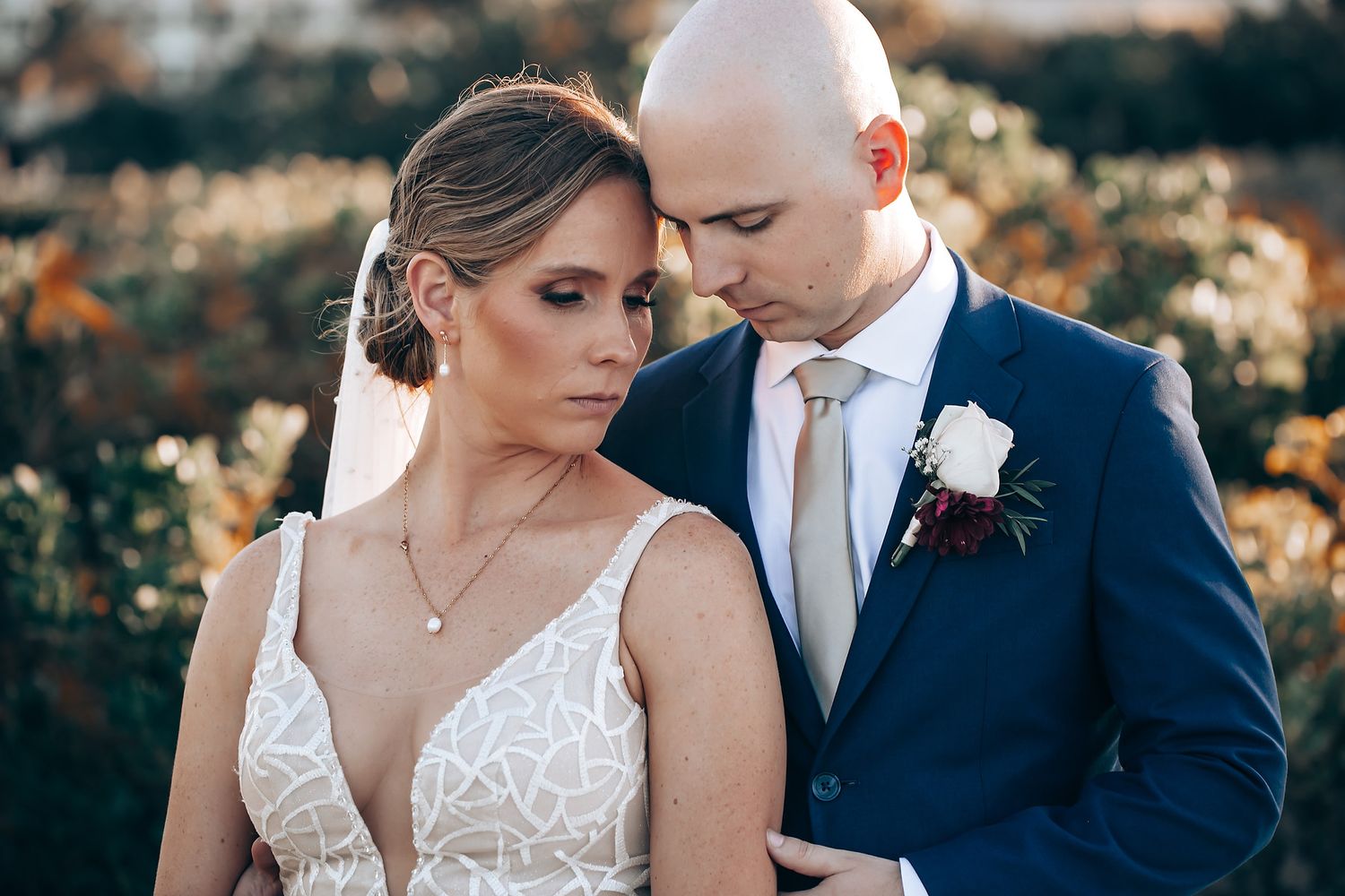 A bride and groom sharing a romantic moment during their wedding ceremony.