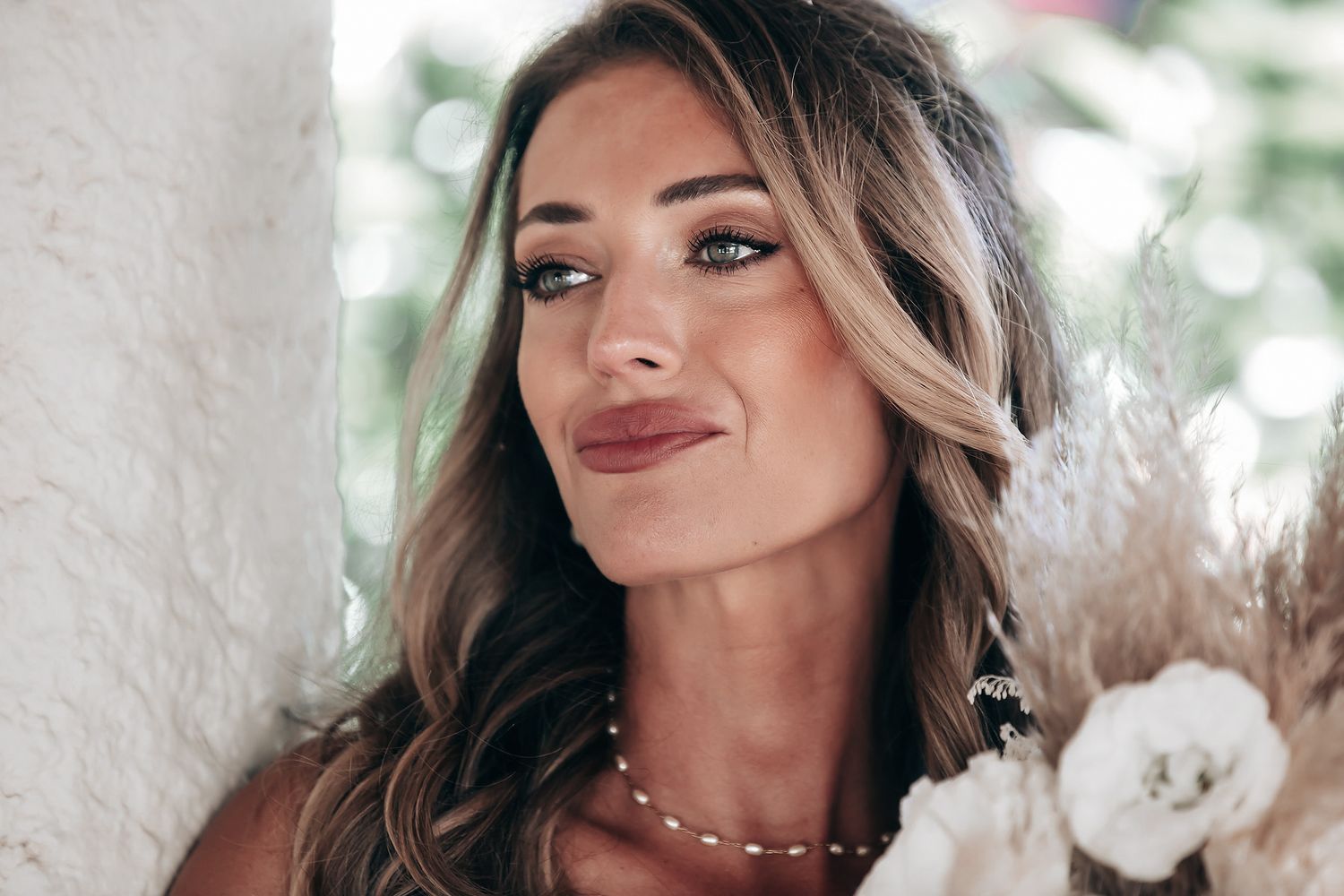 A woman with long dark hair smiles at the camera.