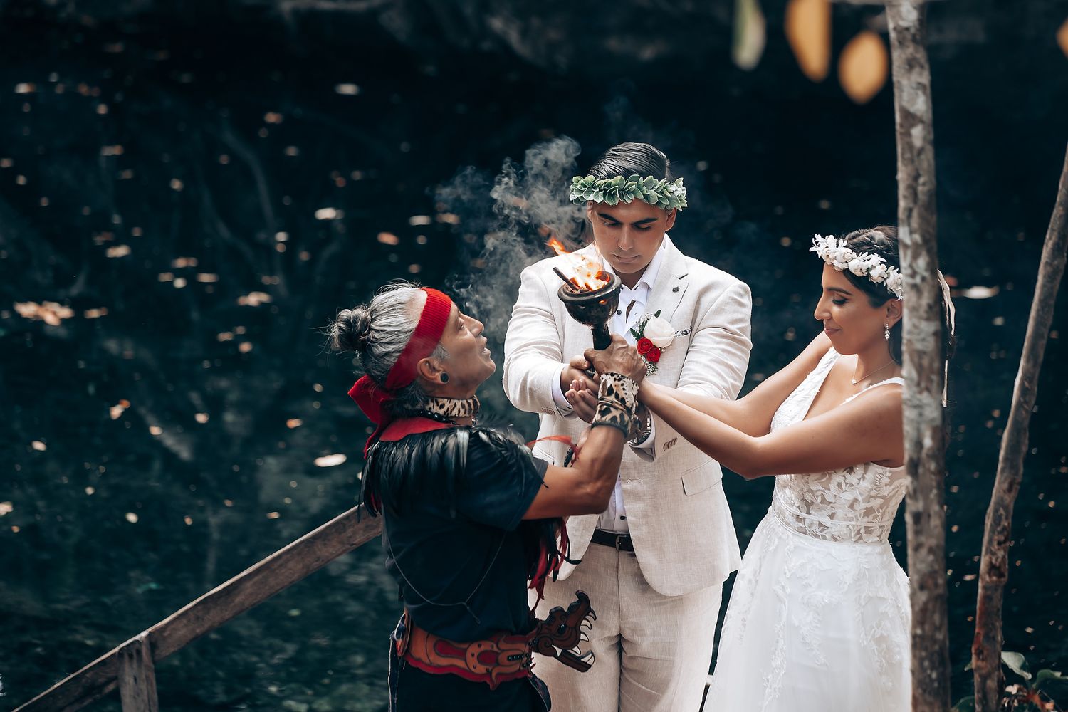 Traditional ceremony with smoke and ritual elements in forest setting.