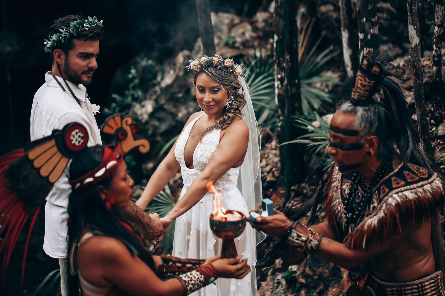 A traditional Hawaiian wedding ceremony with indigenous performers and ceremonial elements in a tropical setting.