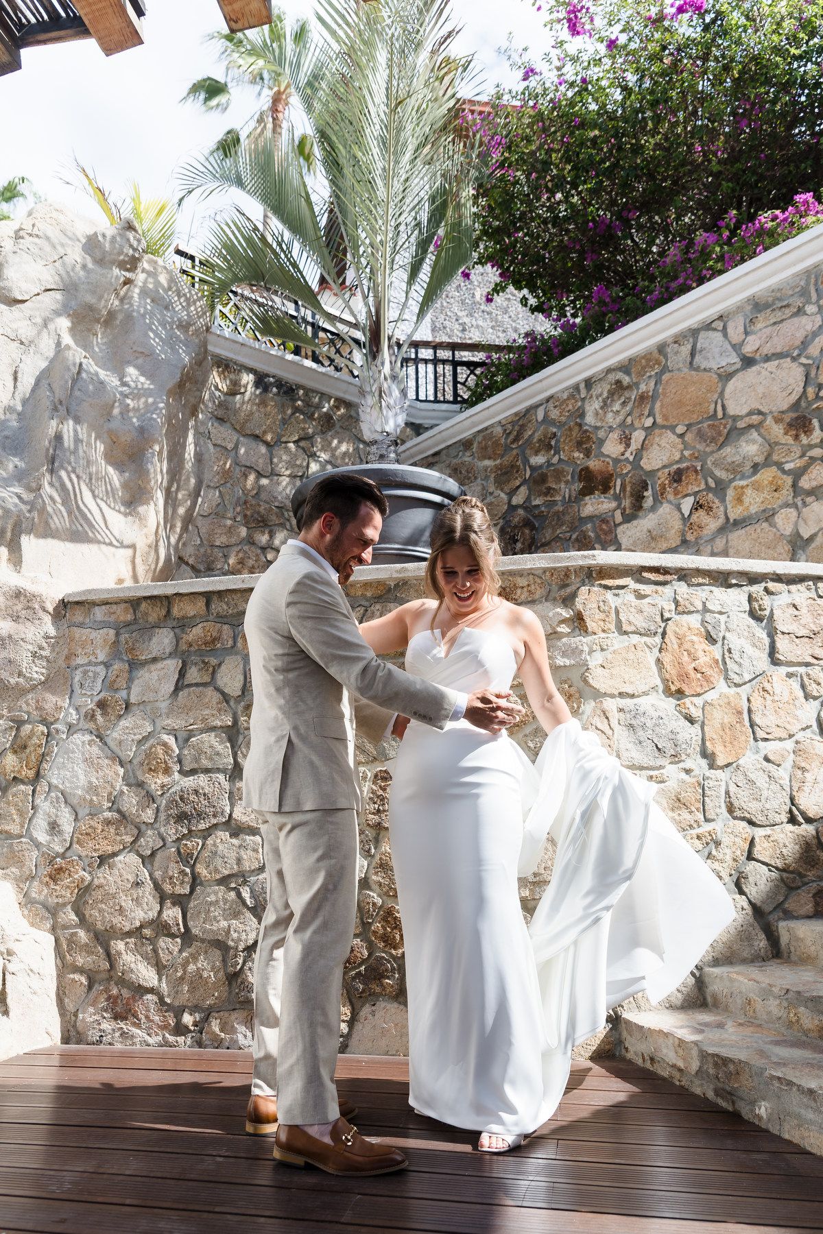 Bride and groom portrait at a Cabo San Lucas wedding with tropical flowers and palm trees.