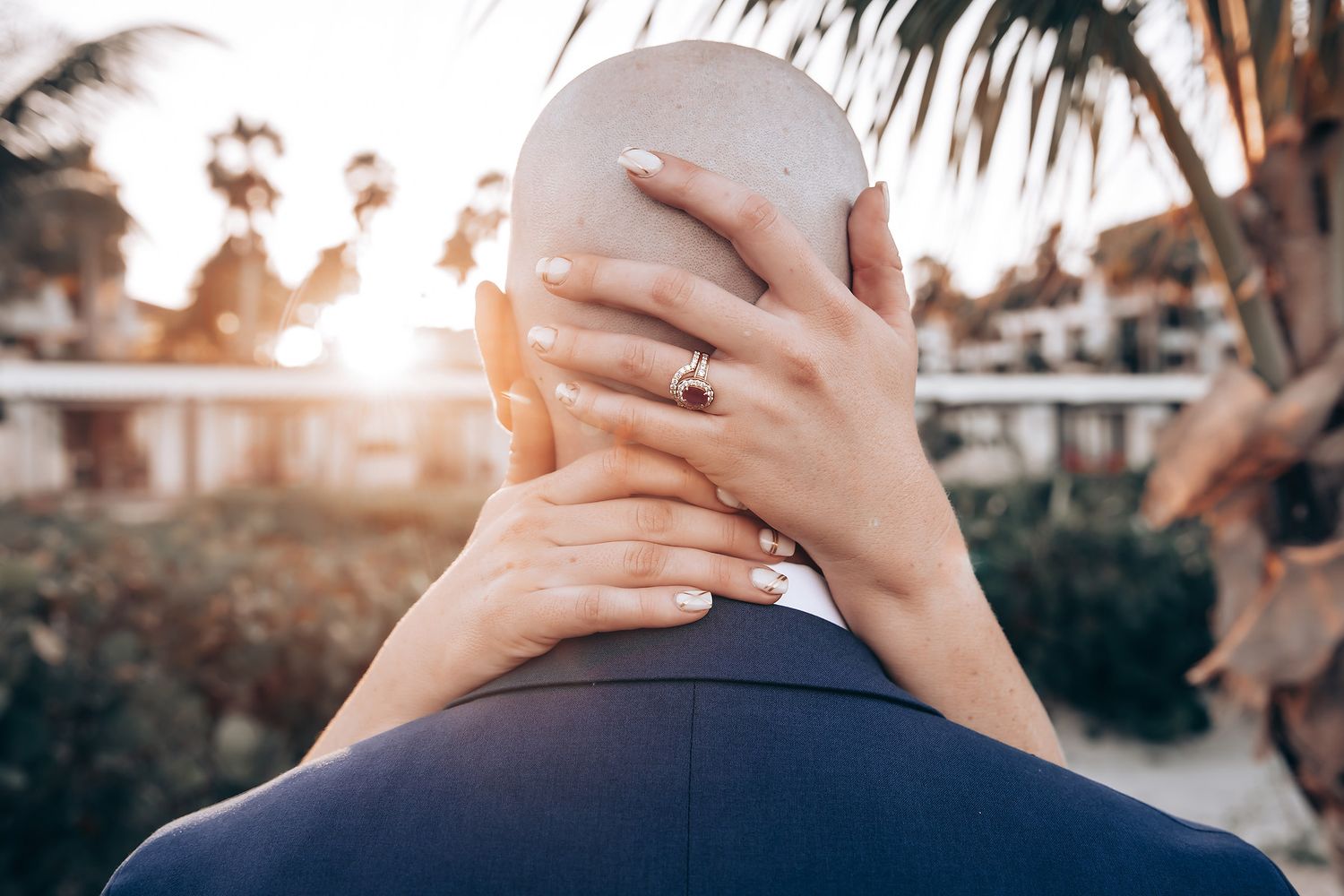A person's hands cover their face in a pensive gesture.