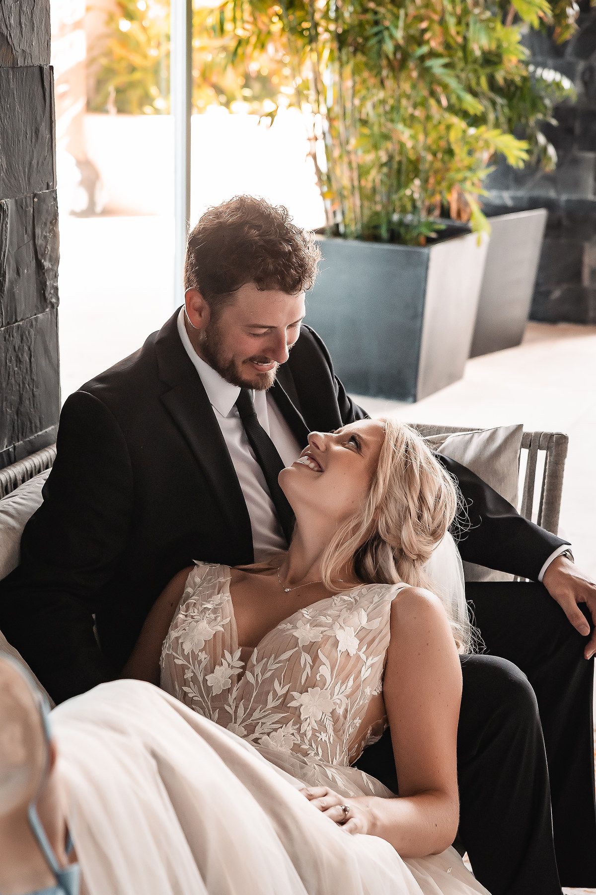 Romantic first look moments between newlyweds in outdoor garden setting.