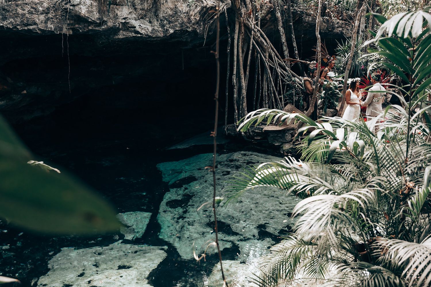 Tropical garden setting with palm trees and natural lighting for an outdoor ceremony.