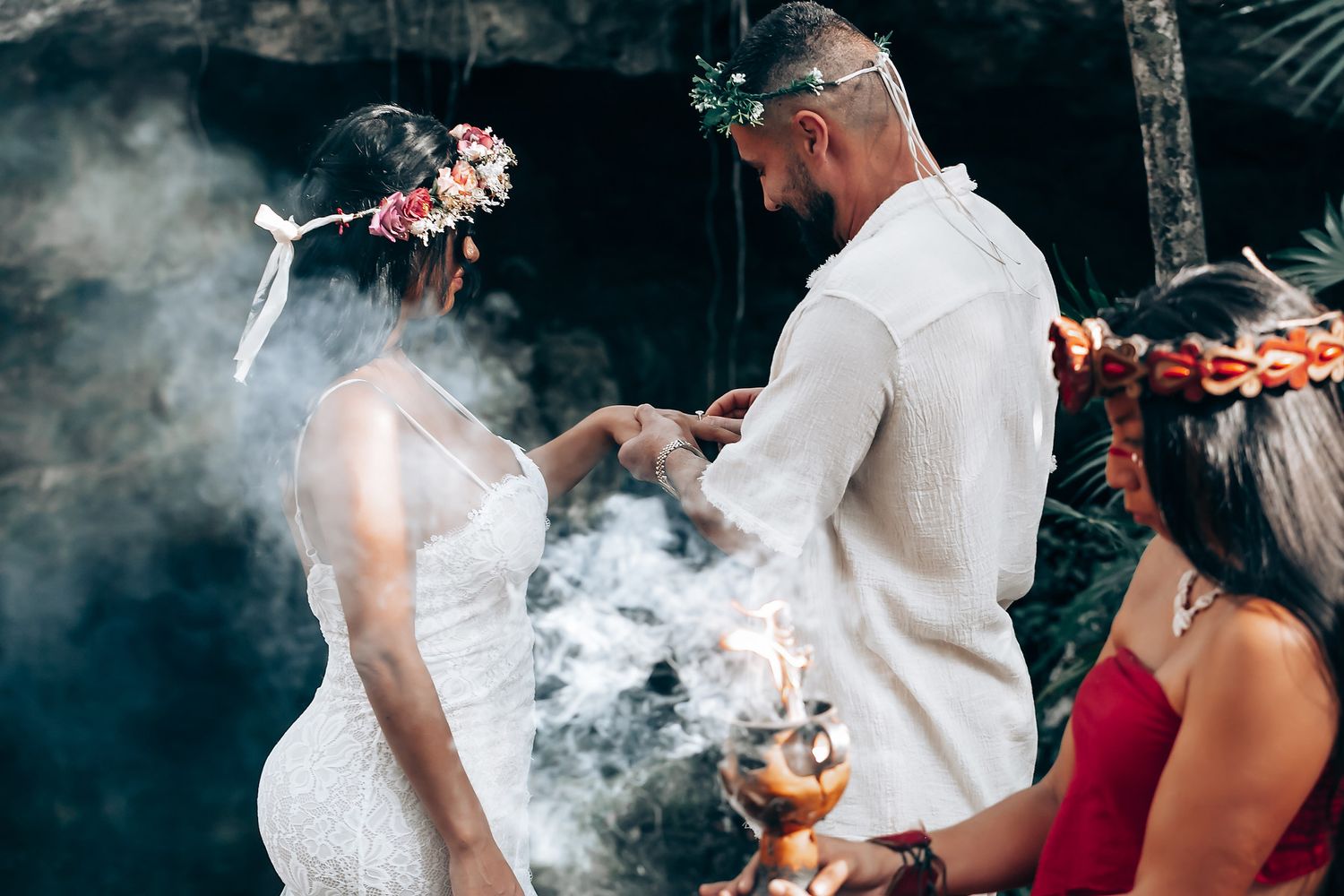 Smoke rises during a spiritual wedding ceremony in an outdoor setting.