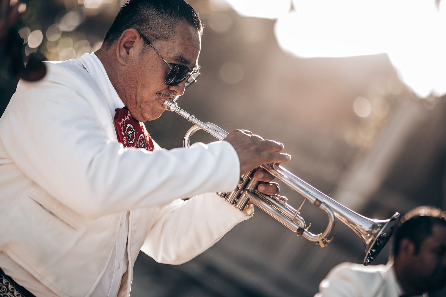 Trumpet player performs soulful music during an outdoor celebration.