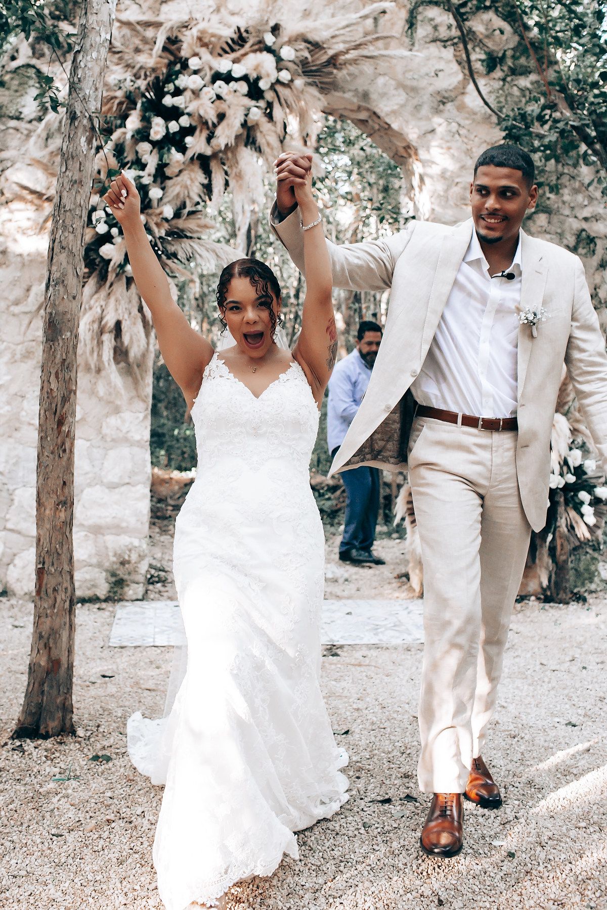 A romantic wedding photo sequence showing a couple dancing and embracing in a garden setting with stone walls.