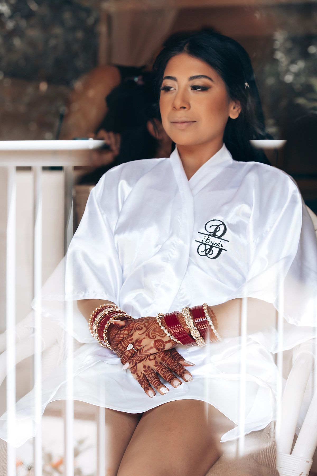 Wedding preparation moment showing white robes with custom monogram details.