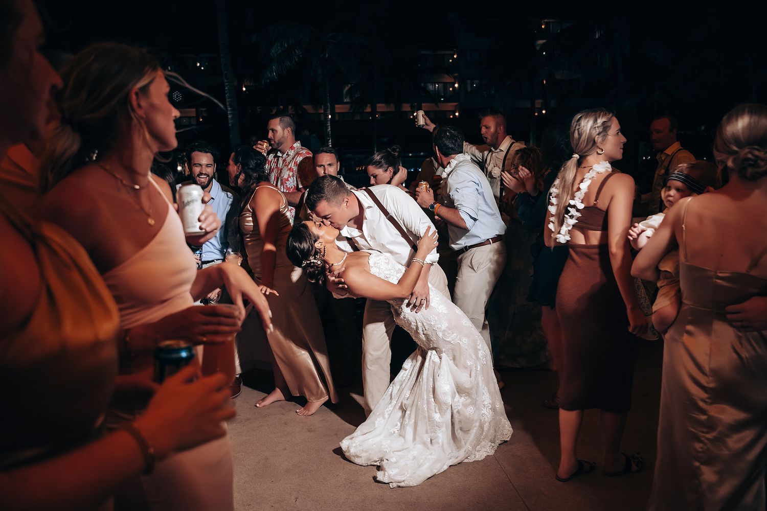 Wedding reception dance floor filled with guests celebrating in the evening.