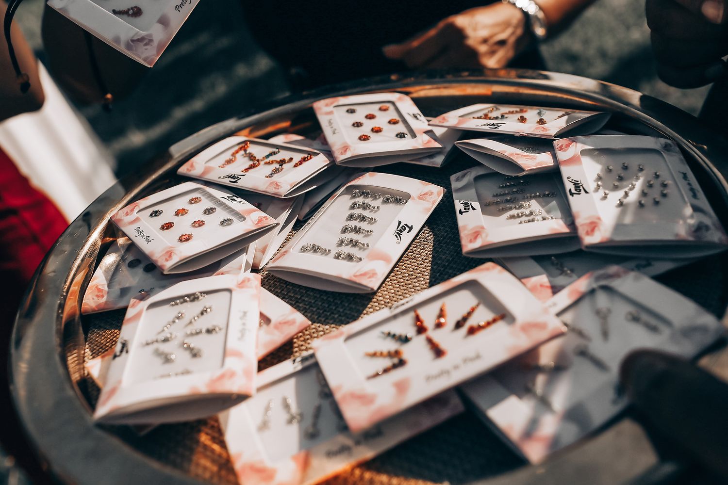 Multiple playing cards scattered across a dark surface creating an artistic arrangement.