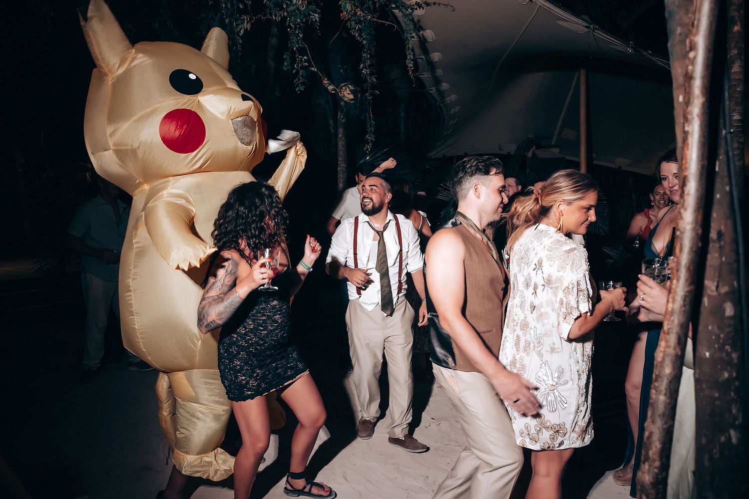 A large inflatable Pikachu mascot entertains guests at an outdoor party venue.