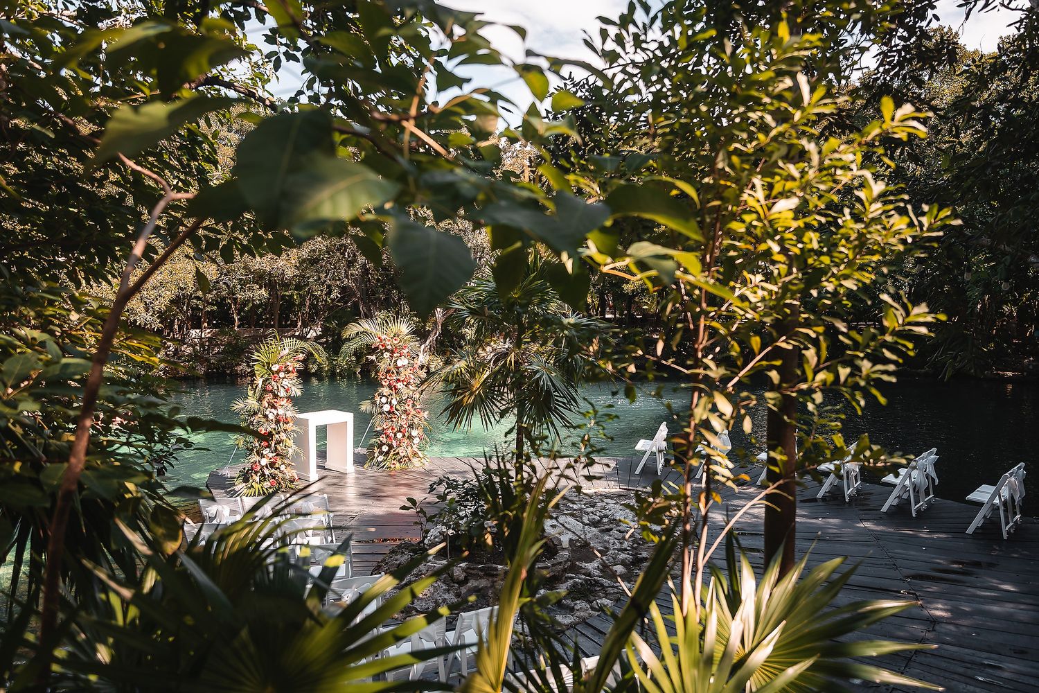 Lush garden wedding venue with stone pathways and tropical landscaping.