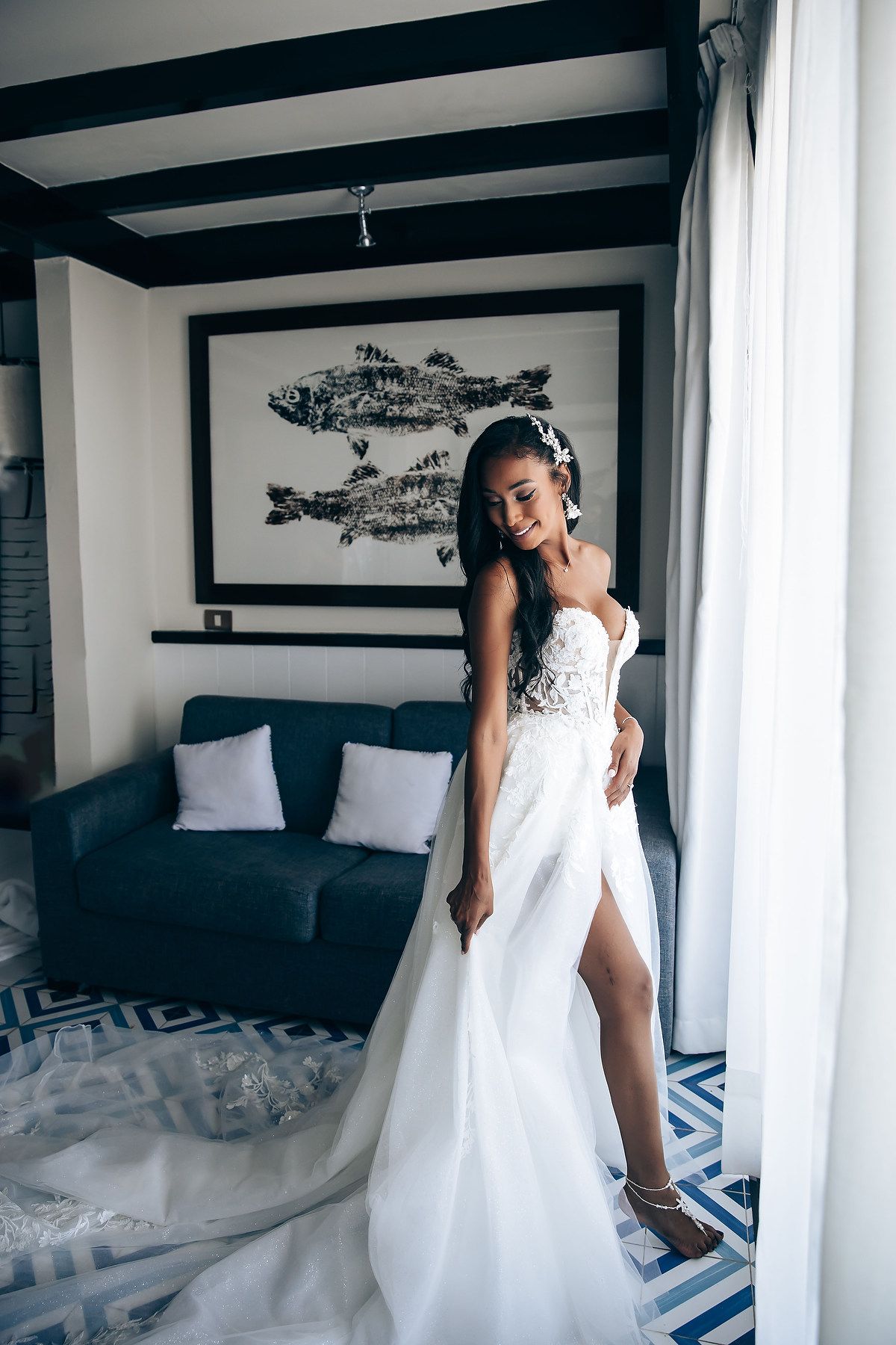 Elegant white wedding gown flowing across modern bedroom with geometric patterns.