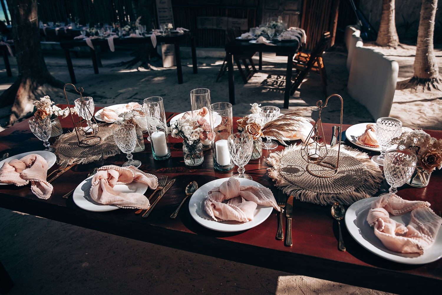 Elegant table settings with wine glasses and place settings at an upscale wedding reception.