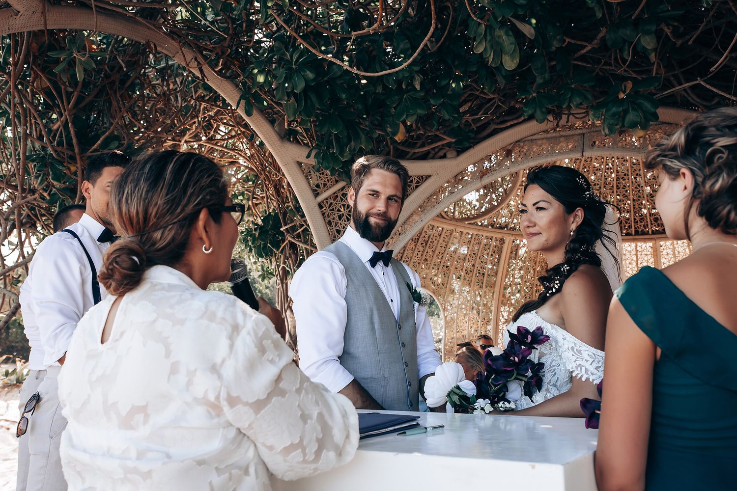 Reception guests mingle and celebrate under decorative outdoor wedding venue.