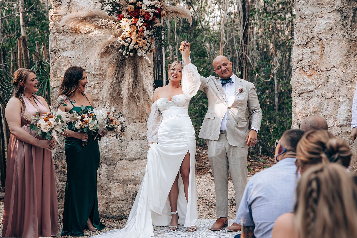 Wedding ceremony in a rustic stone venue surrounded by natural greenery.