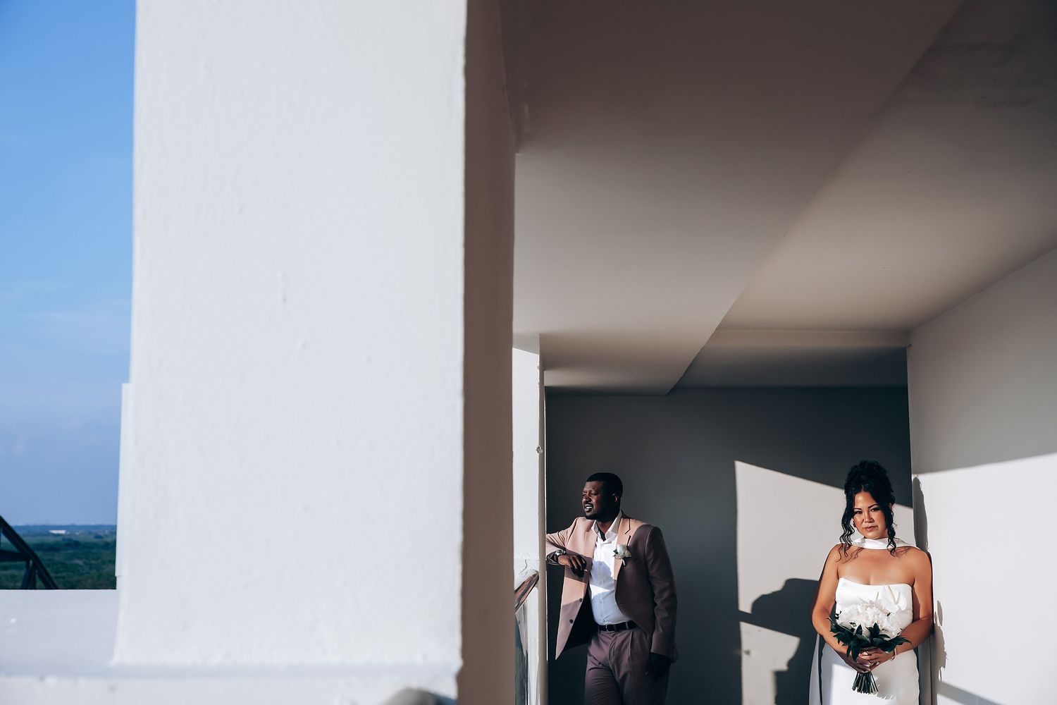 Modern architectural wedding venue with clean white walls and natural lighting.