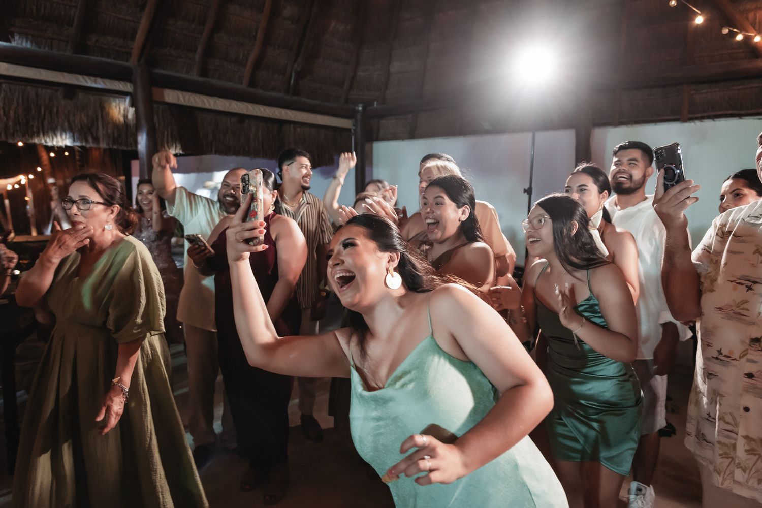 Guests dancing and celebrating joyfully at a tropical wedding reception venue.