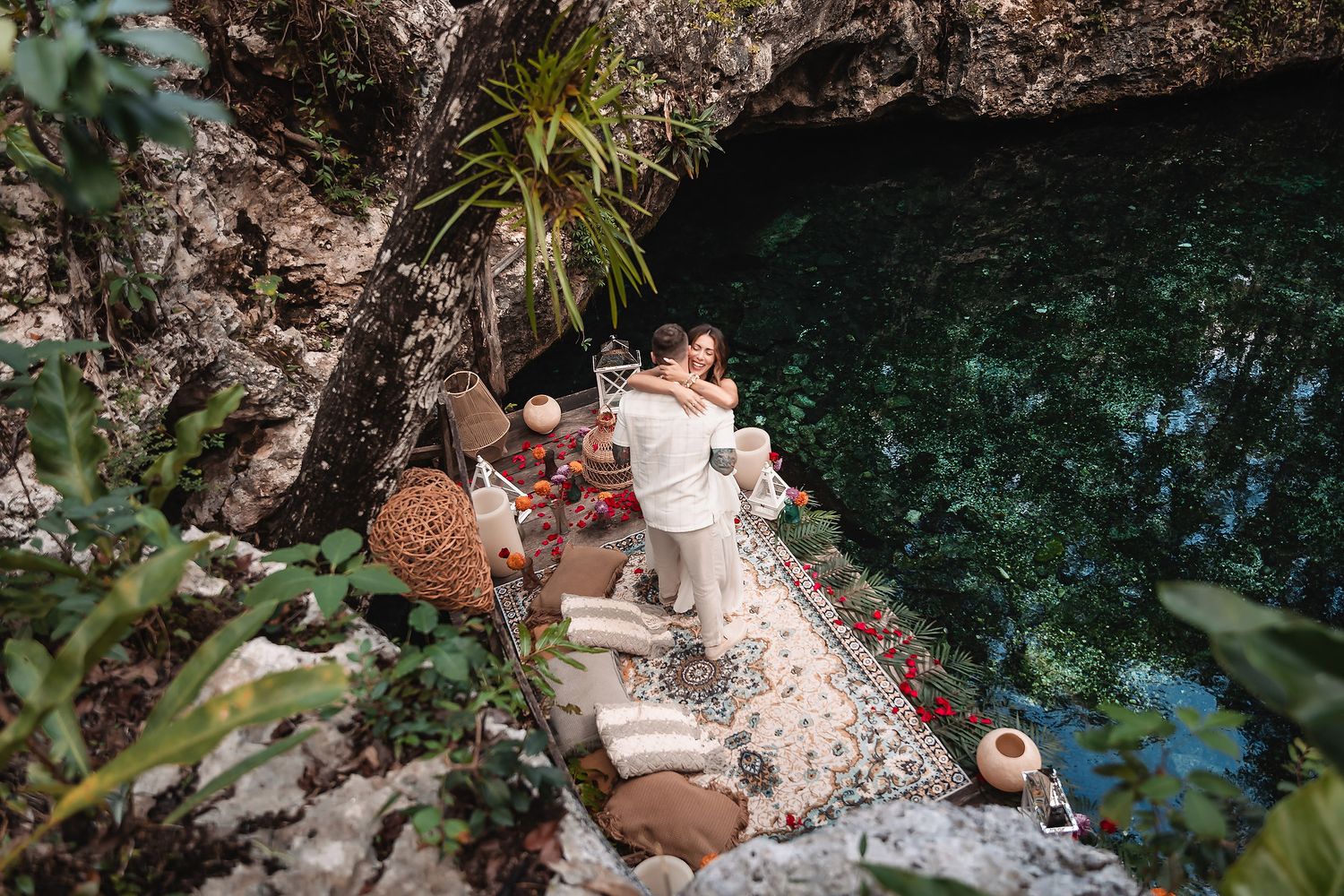 Overhead shot of romantic setup by crystal clear cenote waters.