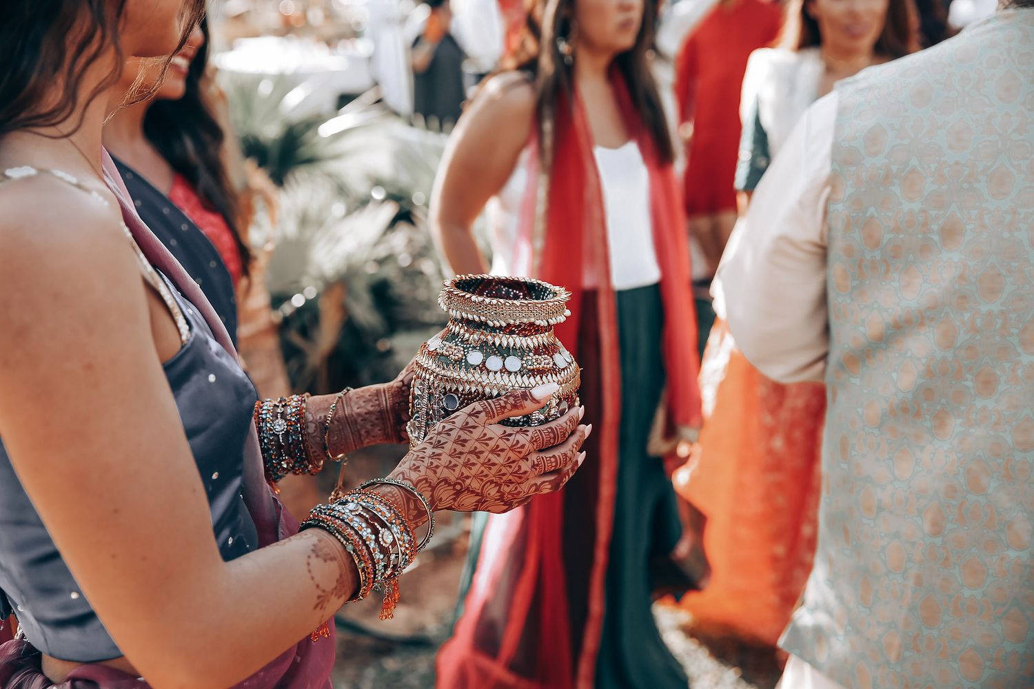 Wedding guests in traditional attire gathered during a cultural celebration ceremony.
