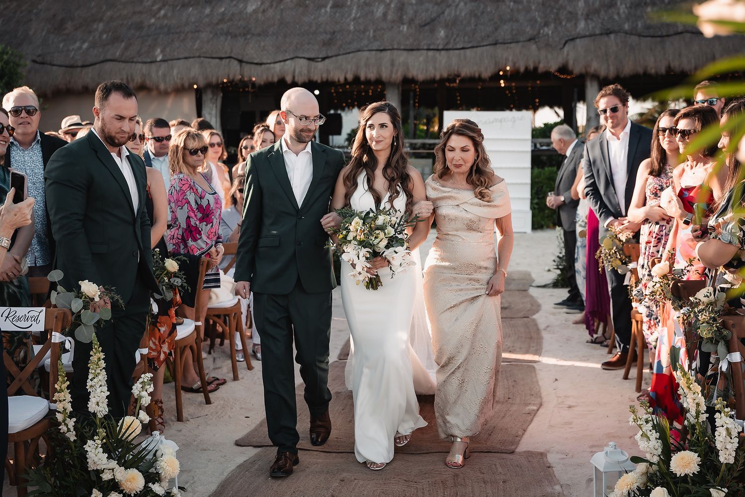 Wedding reception guests dancing and celebrating on a decorated outdoor patio.