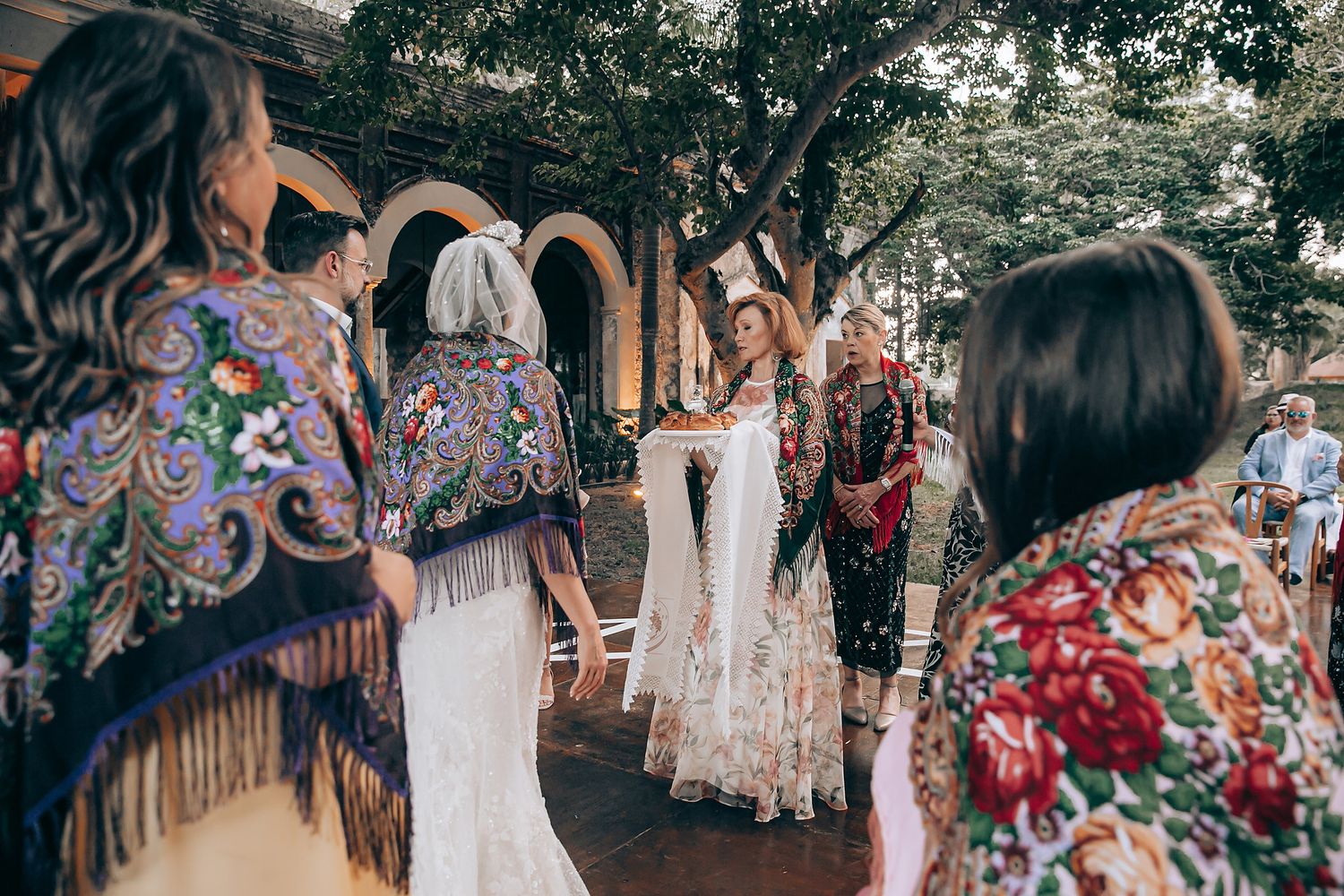 Traditional Mexican folk dancers in colorful dresses perform at an outdoor celebration.