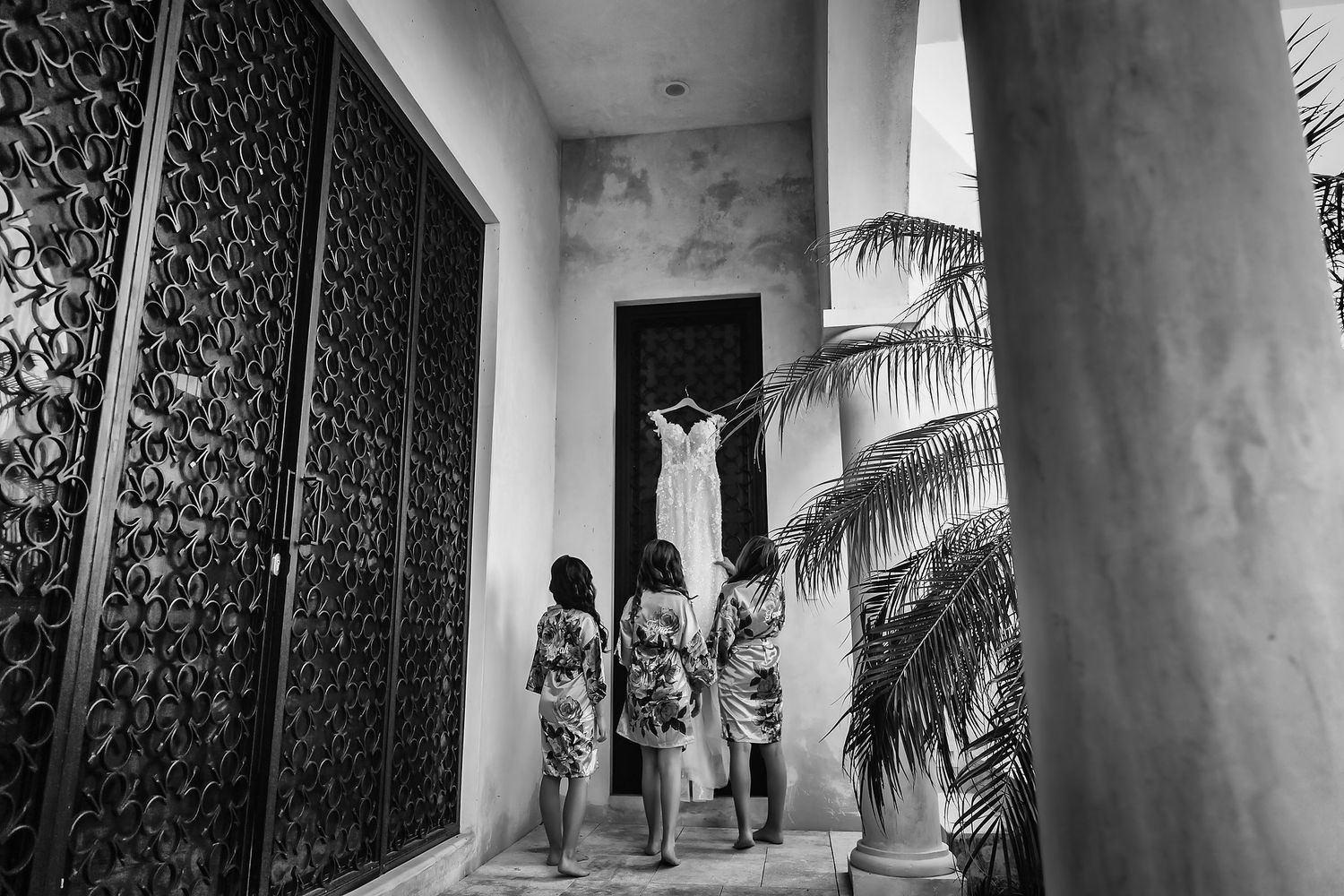 A black and white collage of architectural details showing columns, palm trees and decorative patterns.