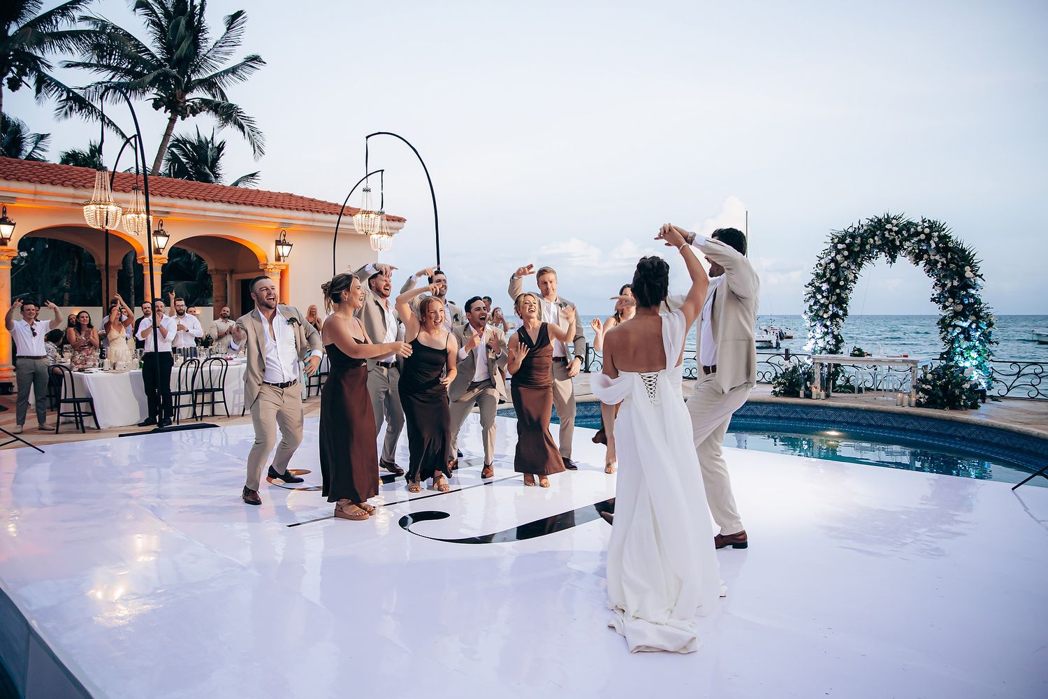 Panoramic sequence of a beach wedding ceremony and reception with palm trees and ocean views at sunset.